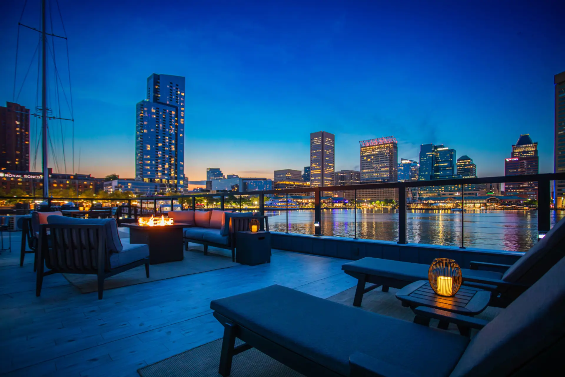 The fire pit is lit. Baltimore is the backdrop. The rooftop is yours.