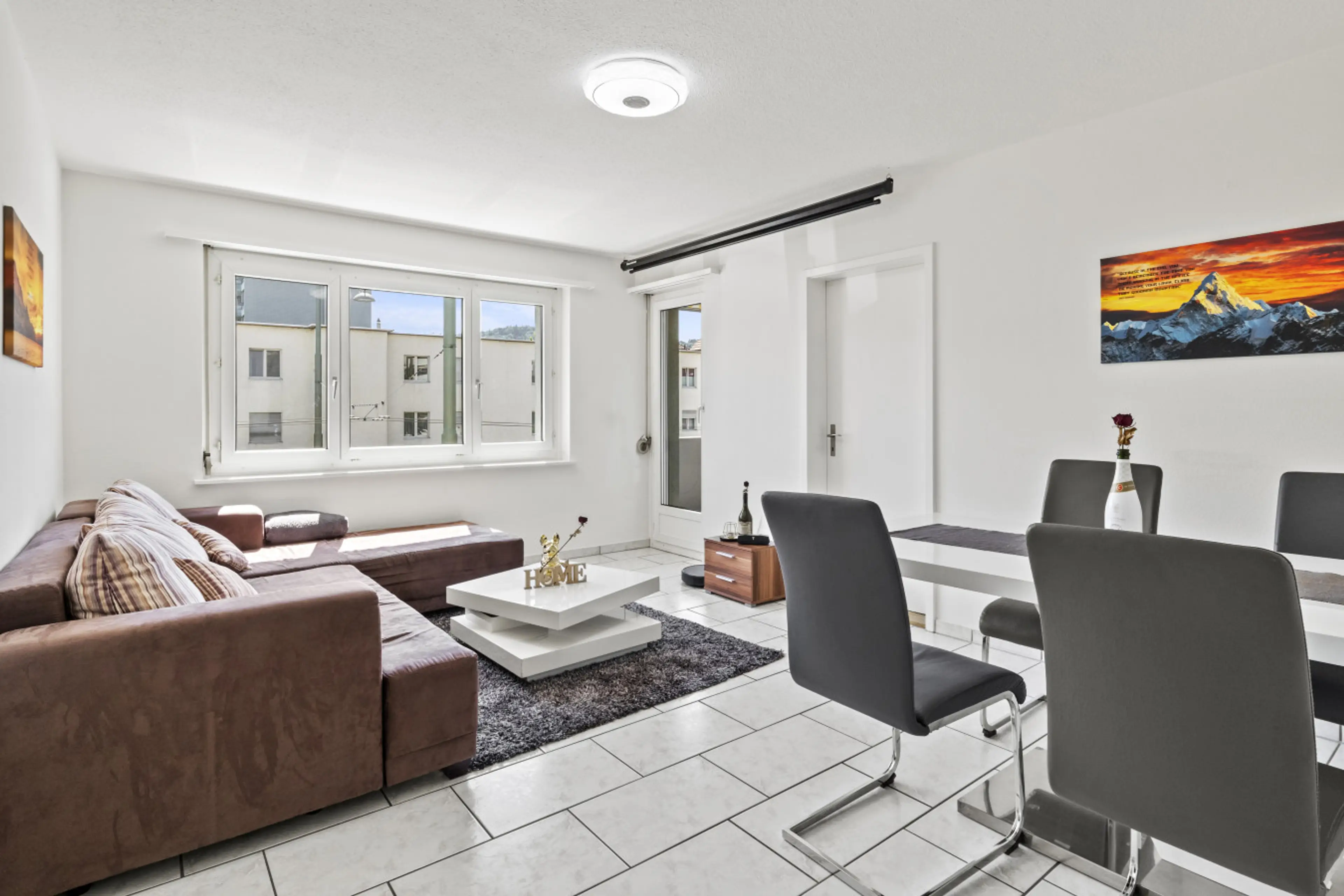 Bright living room with comfy corner sofa, large window and access to the balcony.