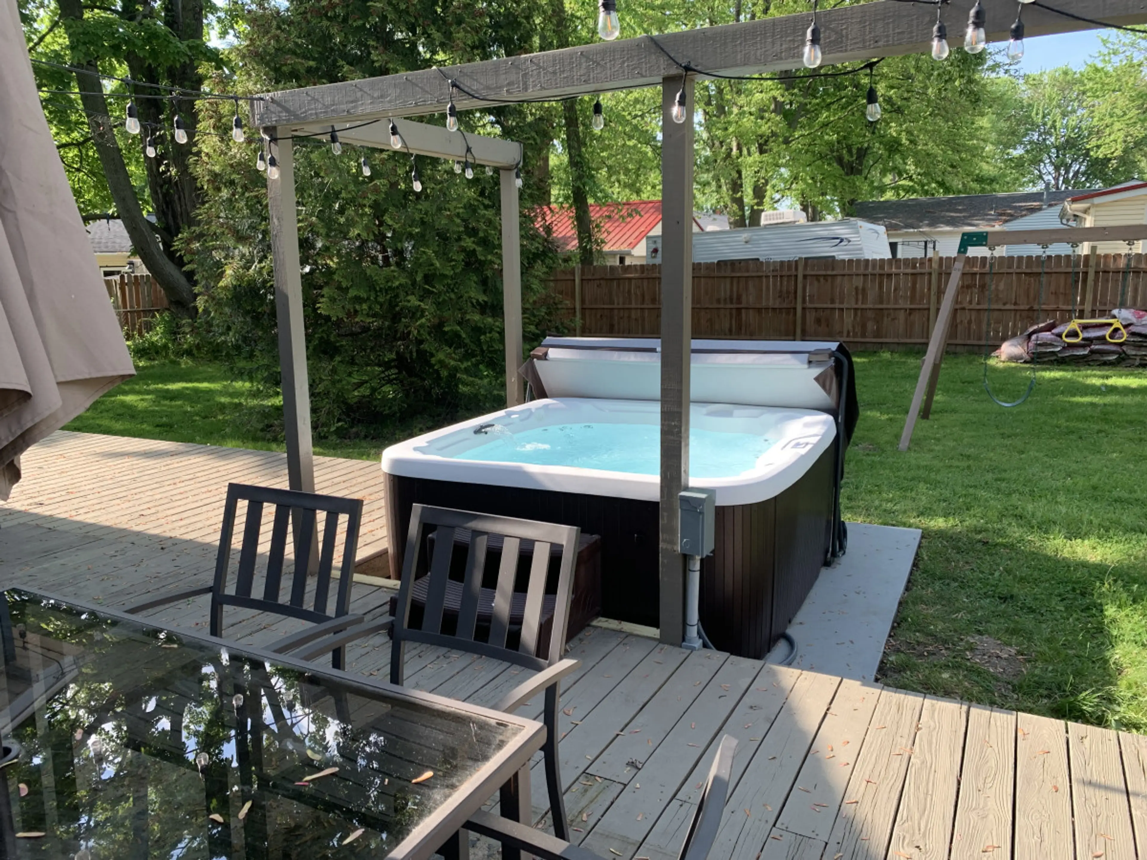 Unwind in the private hot tub under twinkling string lights ✨🛁. Perfect for evening soaks, surrounded by a spacious deck, dining area, and fenced-in yard.