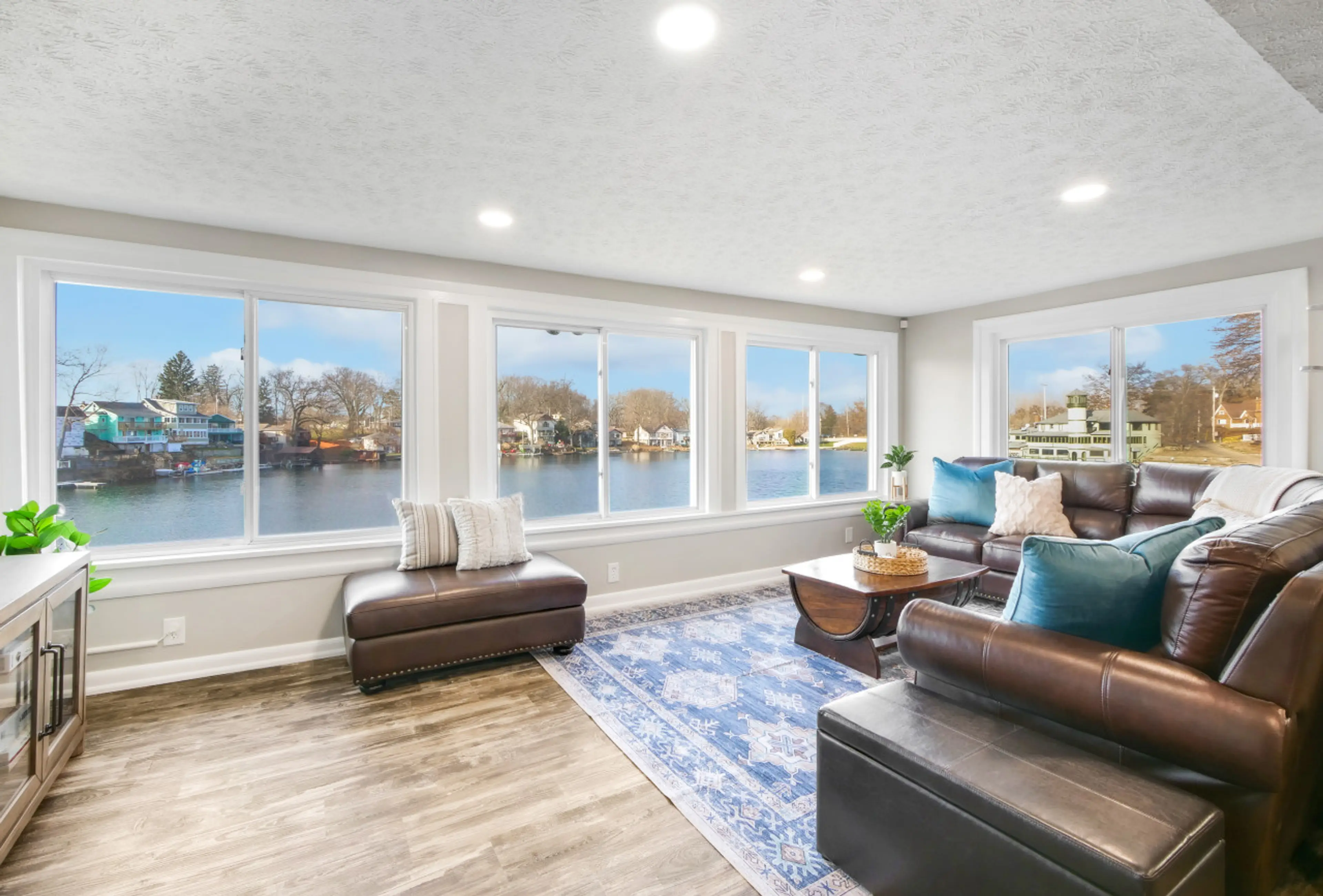 A living room with a breathtaking lake view, where comfort meets nature's beauty for a perfect blend of serenity.