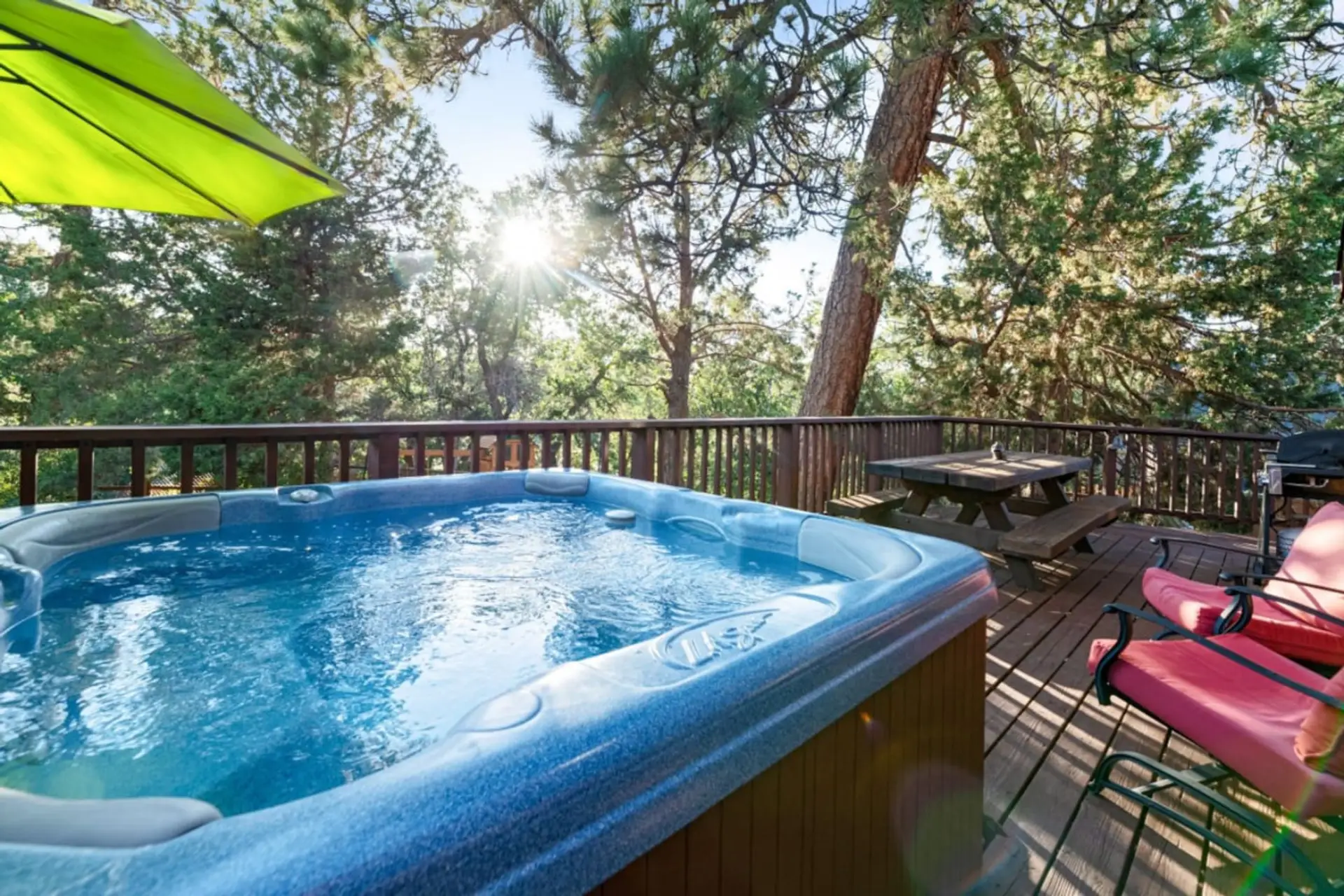 Private hot tub tucked among trees, ideal for unwinding after a day of adventure.
