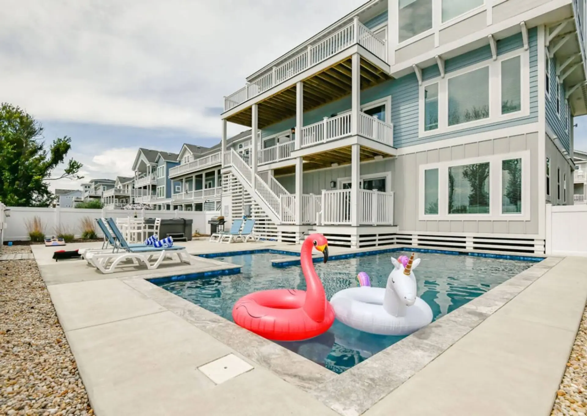 Sunlit private pool w/ loungers & floats, steps from the year-round hot tub on the same deck.