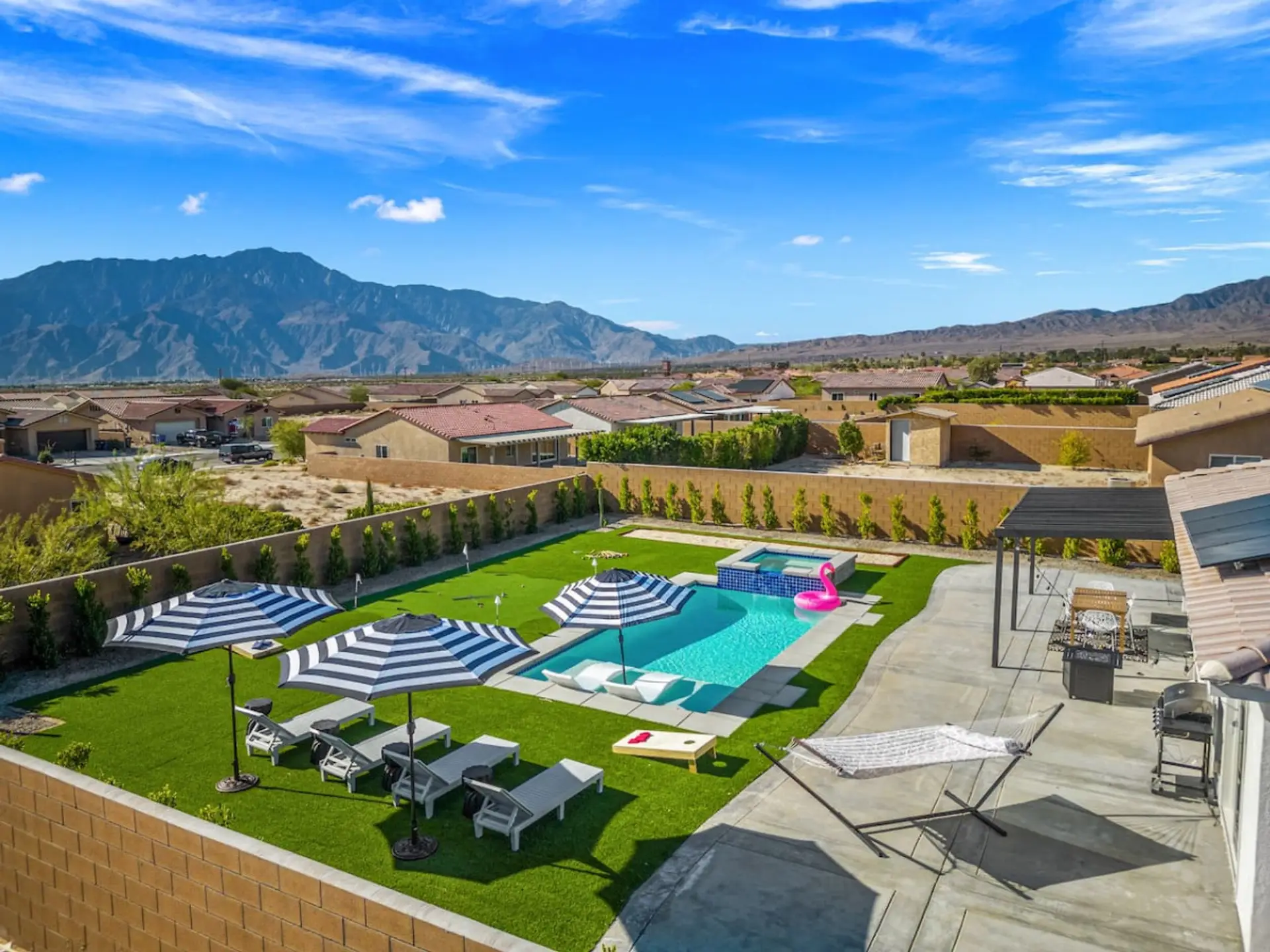 Elevated view of the backyard showing the pool, spa & surrounding space designed for outdoor fun.