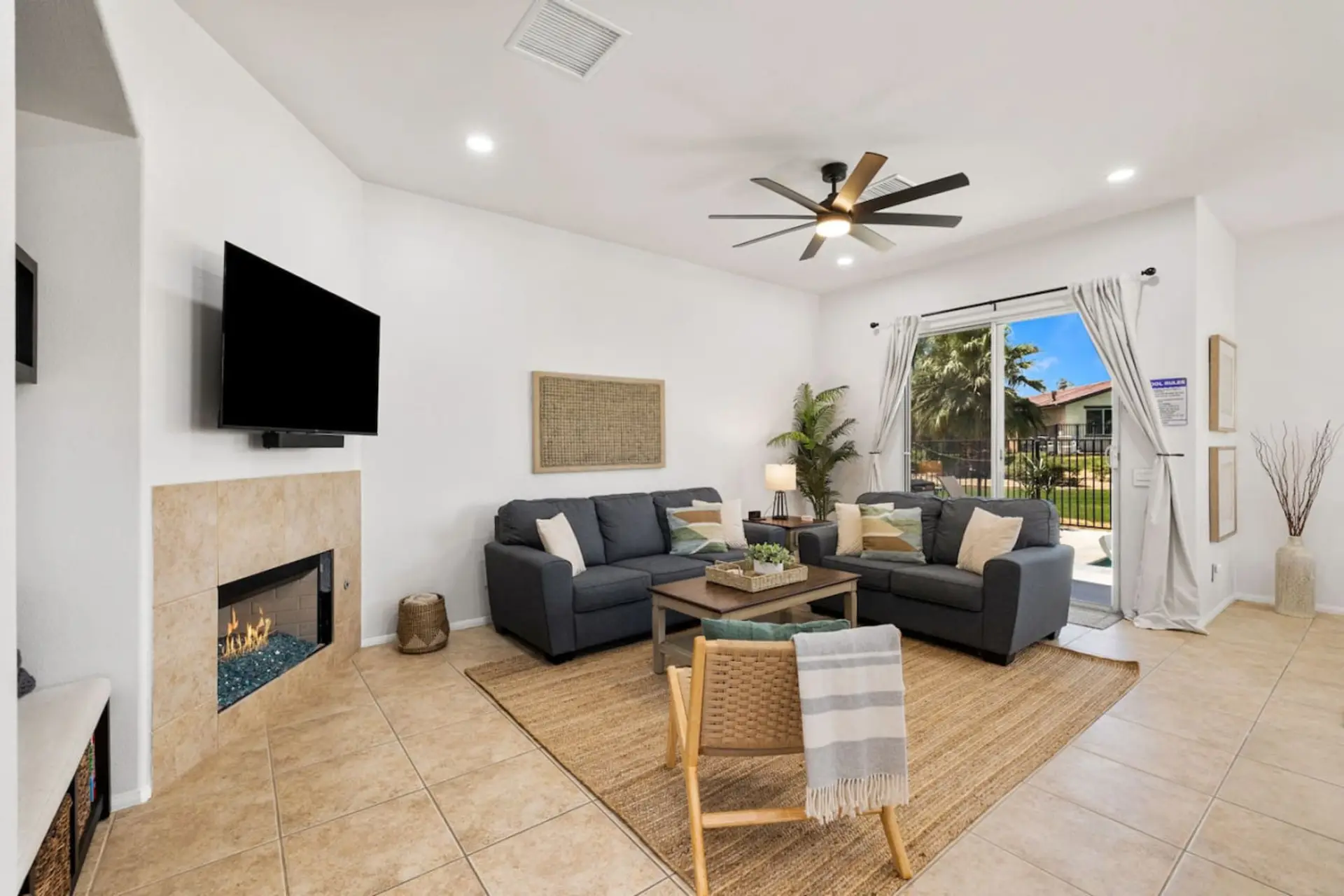 Bright living room w/ comfy seating, fireplace & TV for easy lounging after a full day.