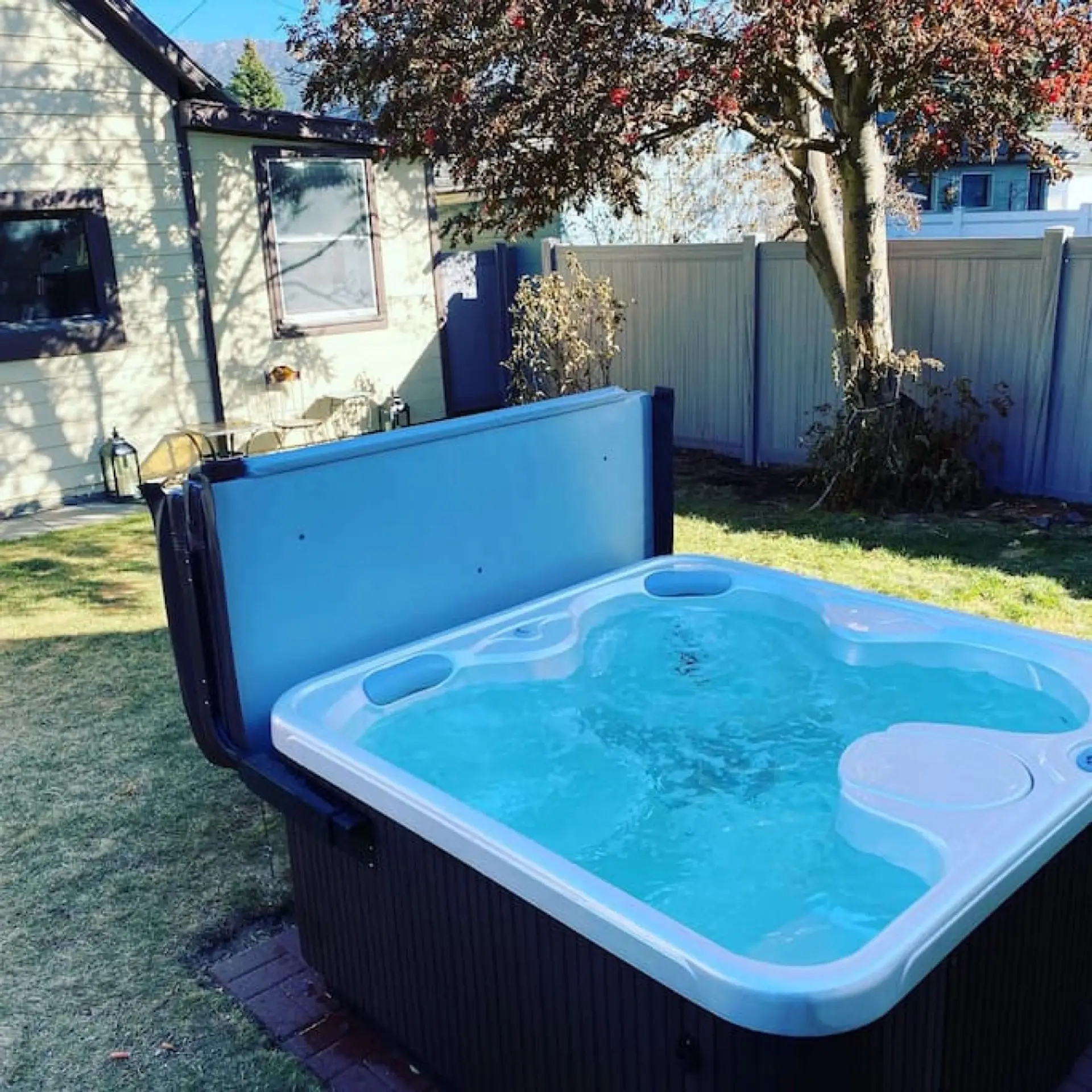 Backyard with hot tub, and string lights