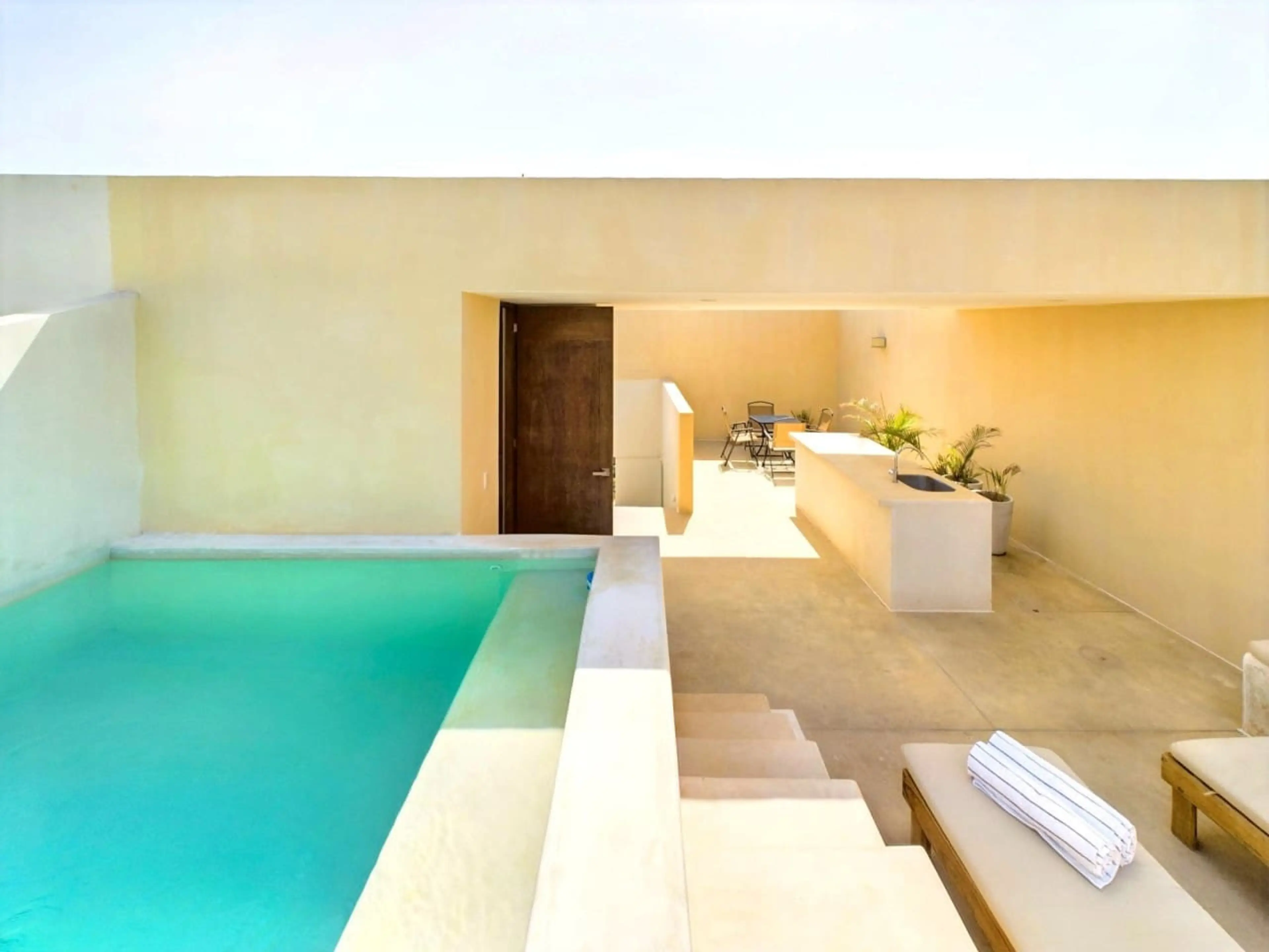 Uncover your private oasis on the rooftop terrace, featuring a beautiful pool and sunbeds for the perfect relaxation under the Tulum sun.