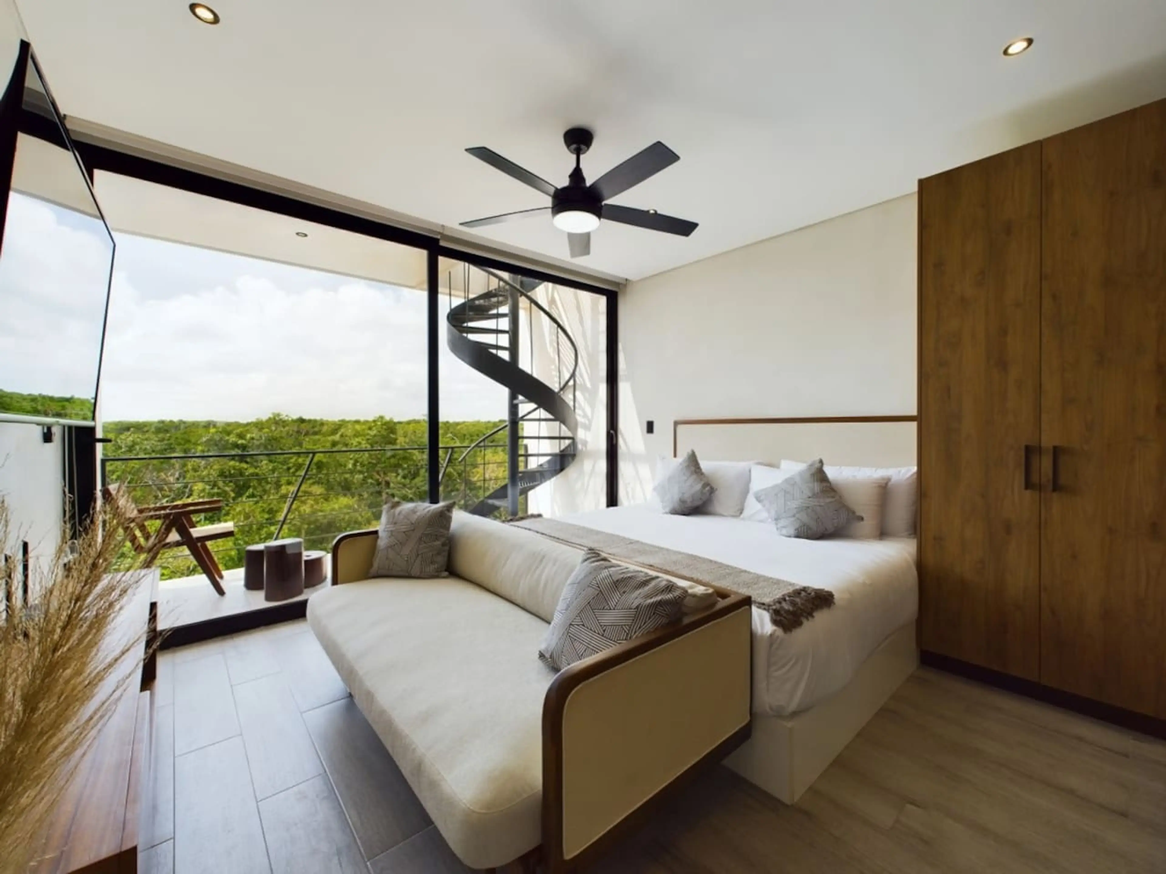 Facing the king-size bed is a chic sofa bed, perfect for accommodating one guest comfortably. Ample storage space is also available to keep your belongings tidy during your stay.