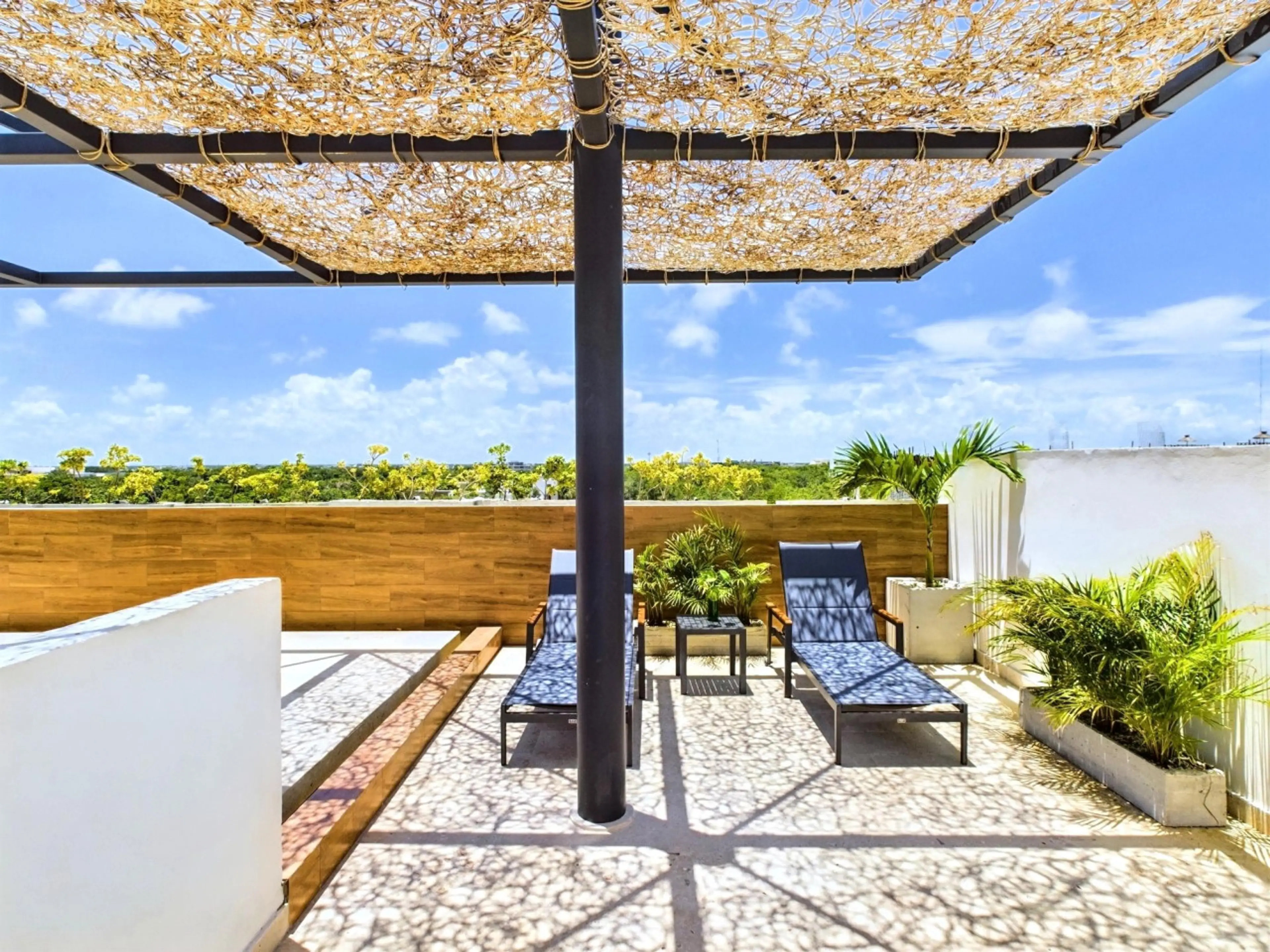 Soak up the sun in comfort on Palais Tulum’s terrace, where inviting armchairs and a serene atmosphere create the ideal spot for ultimate relaxation.