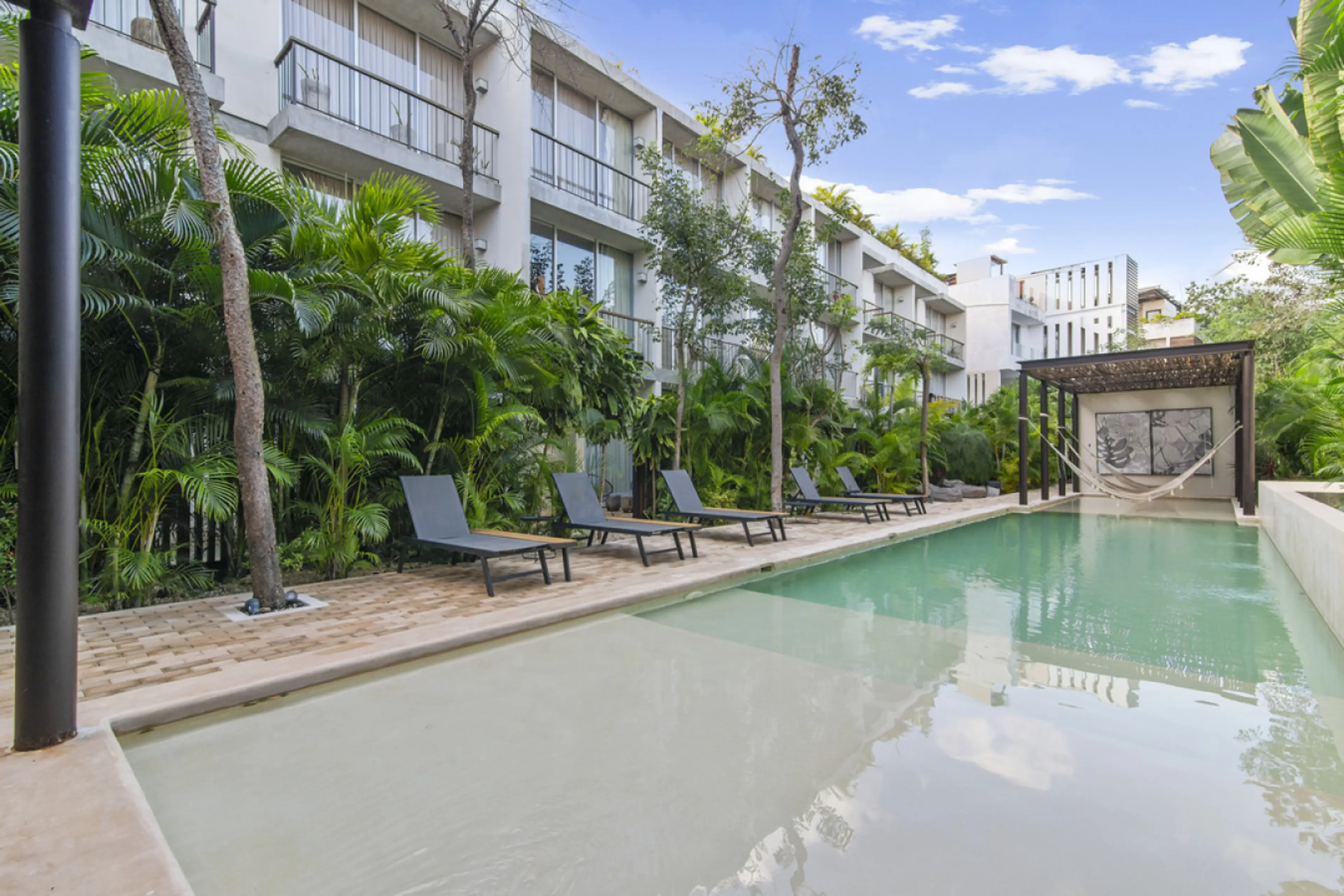 A peaceful and inviting space, the pool area is perfect for lounging, chatting, or soaking up the Tulum vibes.