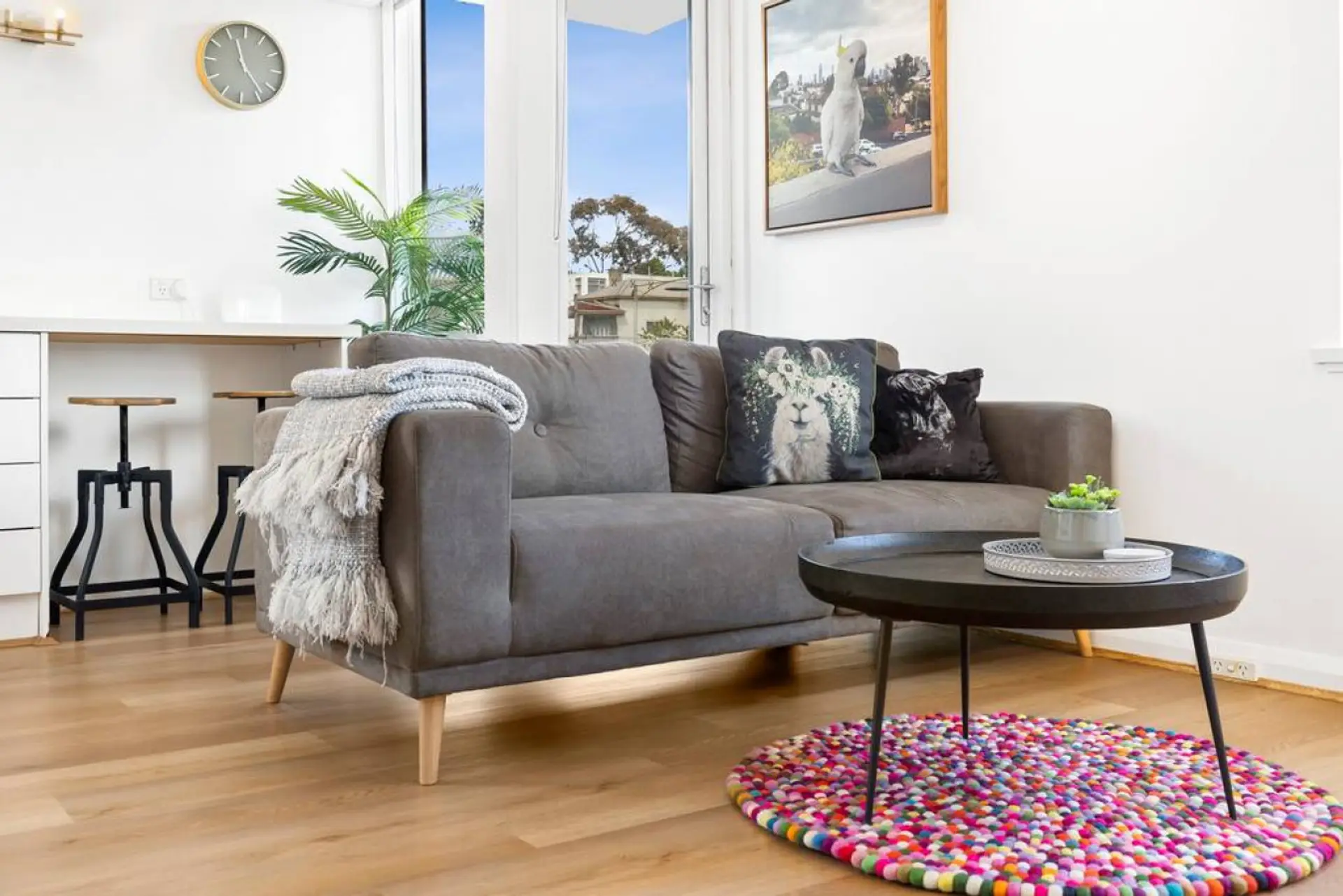 Sink into the inviting sofa and enjoy the playful decor, natural light, and stylish touches that make this space feel warm and welcoming
