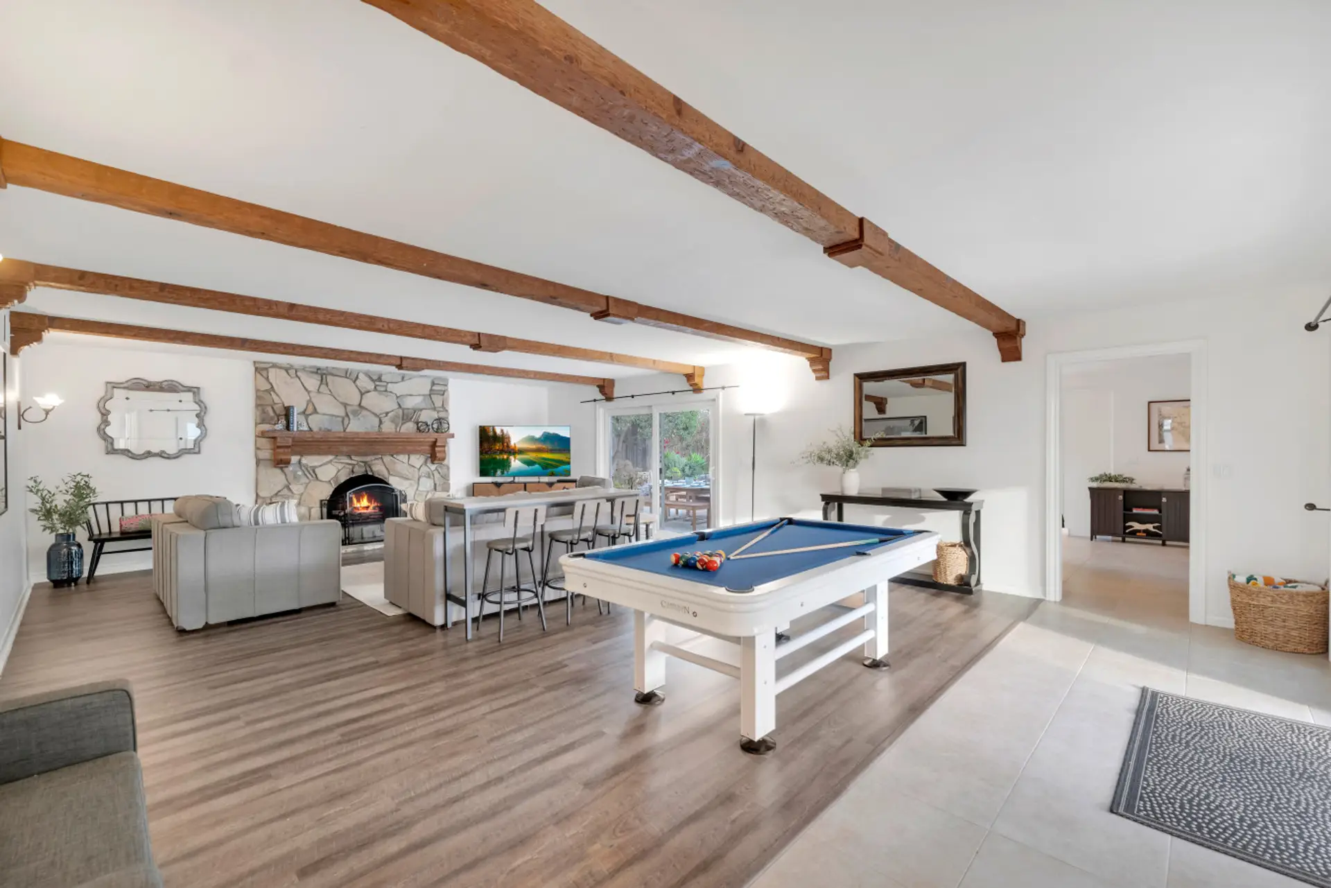 Living room with pool table adjacent to jacuizzi and kitchen patios