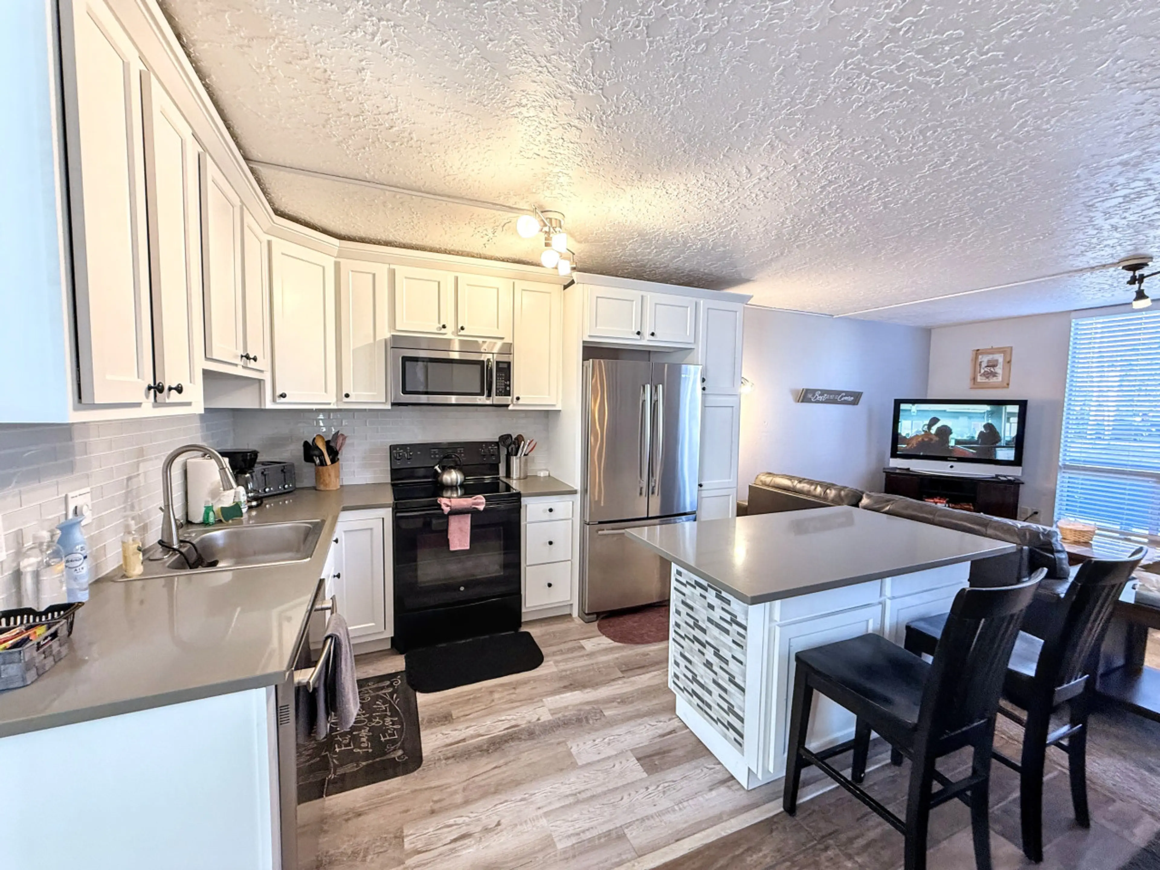 Fully Stocked Kitchen with Island and Bar Seating