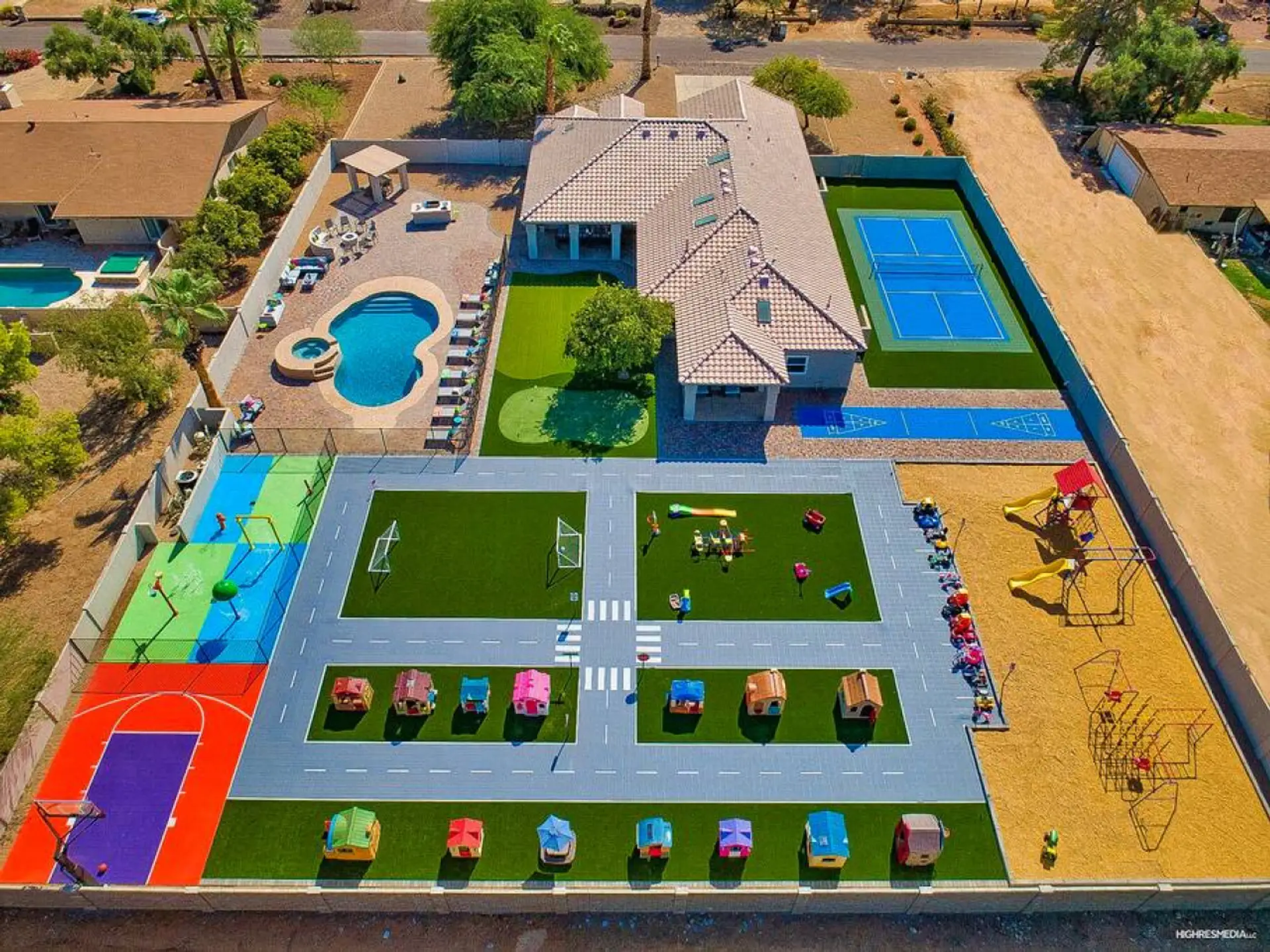 [Resort Property] Aerial view showing entire property featuring a Resort Style heated pool and spa, splashpad, pickleball court, shuffleboard, and playgrounds
