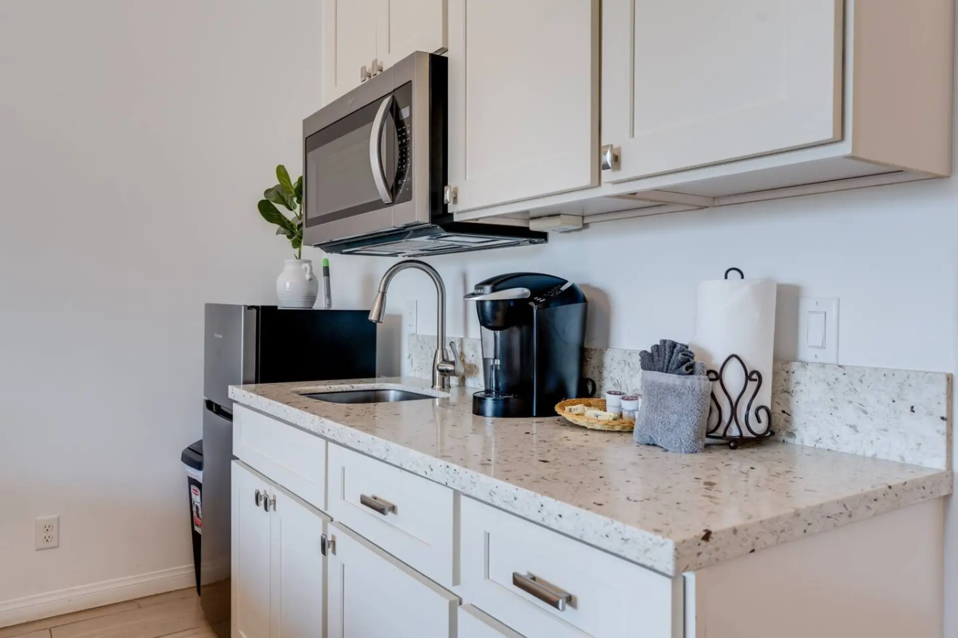 Kitchenette equipped with essential tools for preparing small meals. There is no stove or oven, but it includes a portable hot plate, skillet, and other basic cookware
