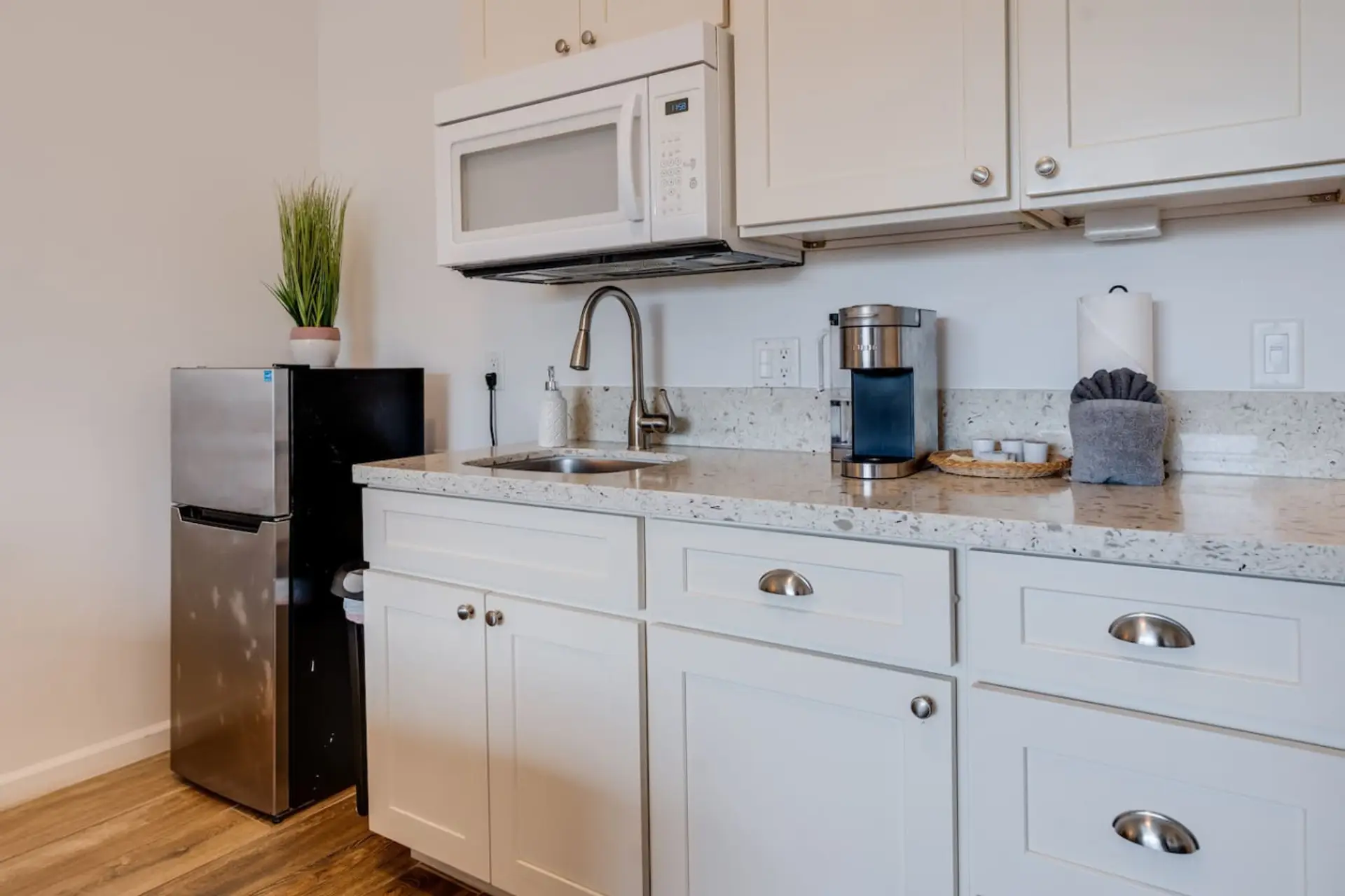 Kitchenette equipped with essential tools for preparing small meals. There is no stove or oven, but it includes a portable hot plate, skillet, and other basic cookware