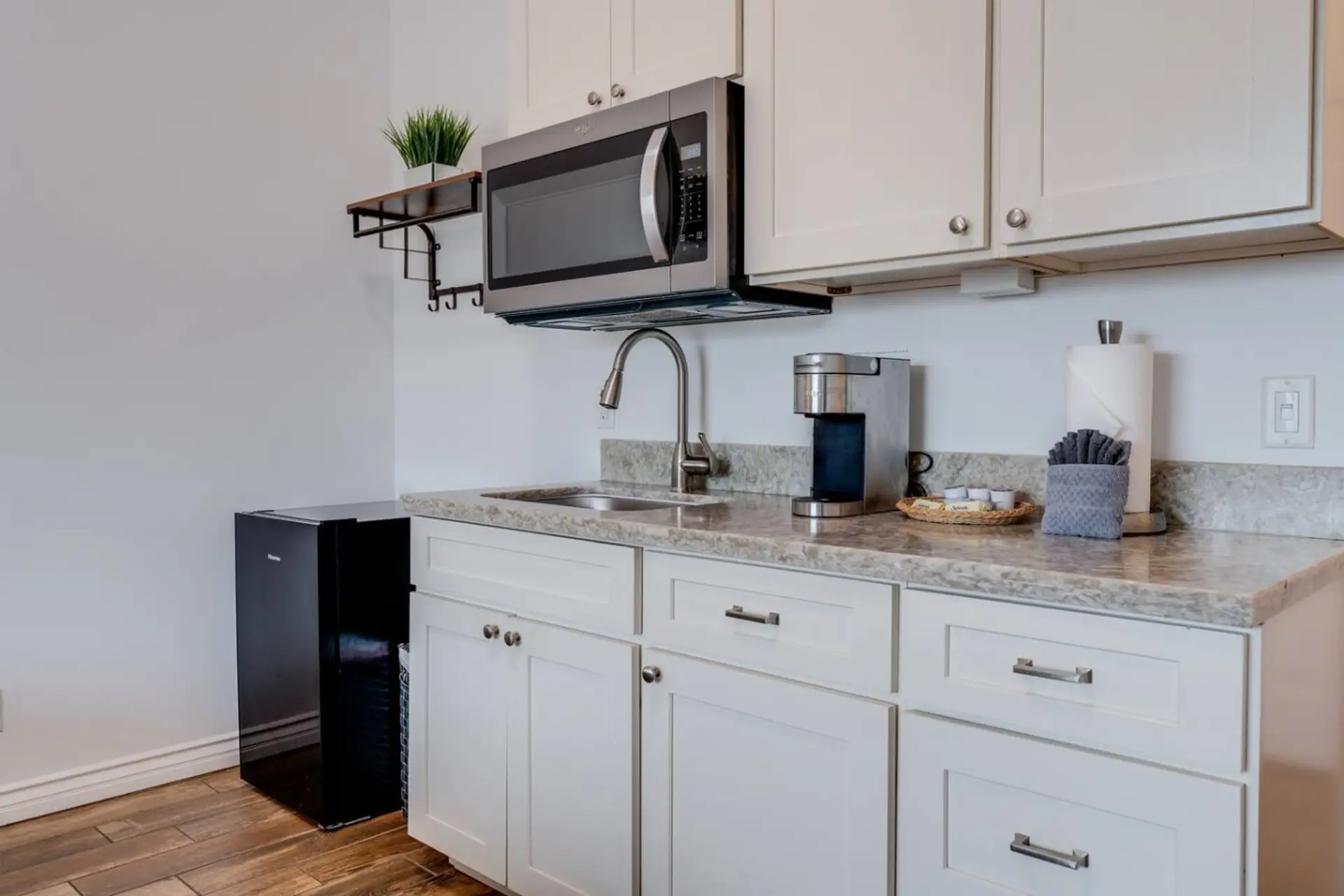 Kitchenette equipped with essential tools for preparing small meals. There is no stove or oven, but it includes a portable hot plate, skillet, and other basic cookware