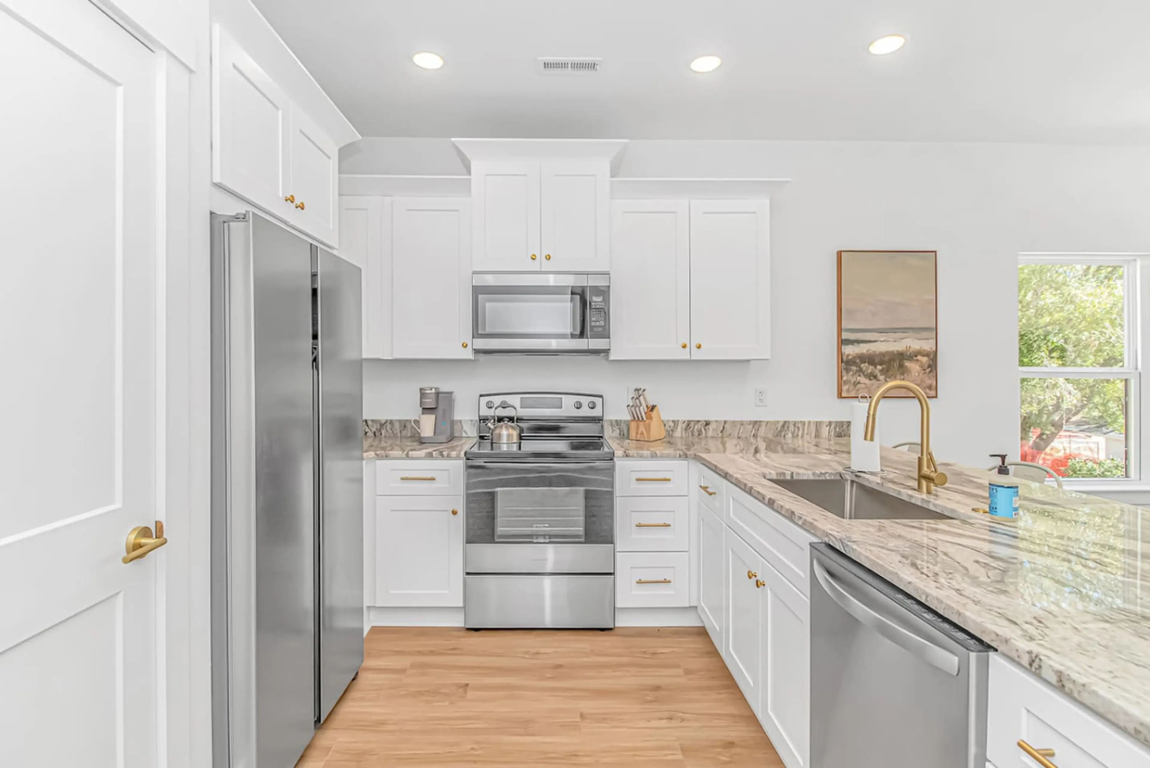 Modern kitchen with stainless steel appliances, granite counters, and full amenities