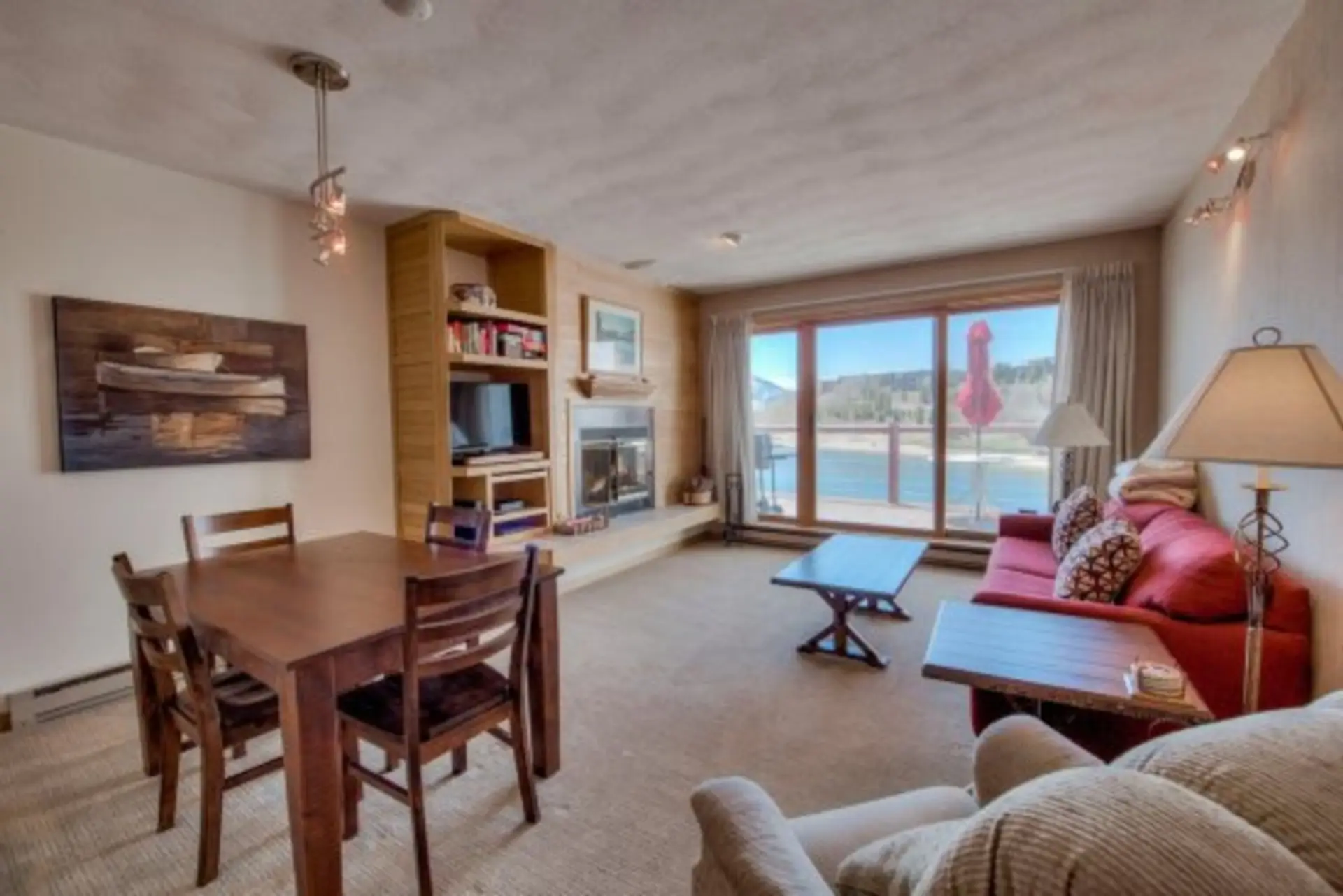 This quaint and cozy living room boasts a gorgeous fire place and gorgeous windows