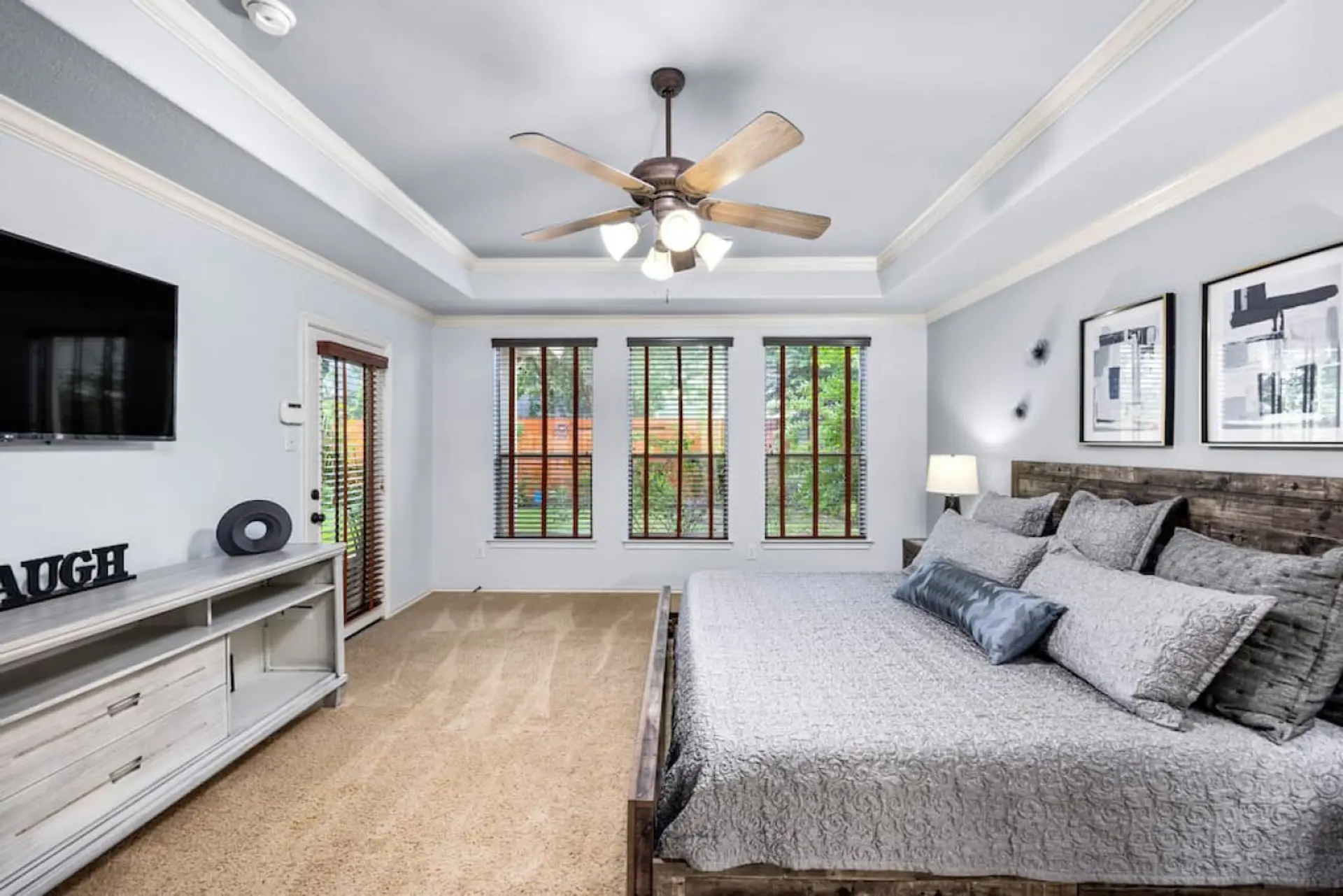 Spacious primary suite with king bed, Smart TV, and backyard views — designed for comfort and privacy.