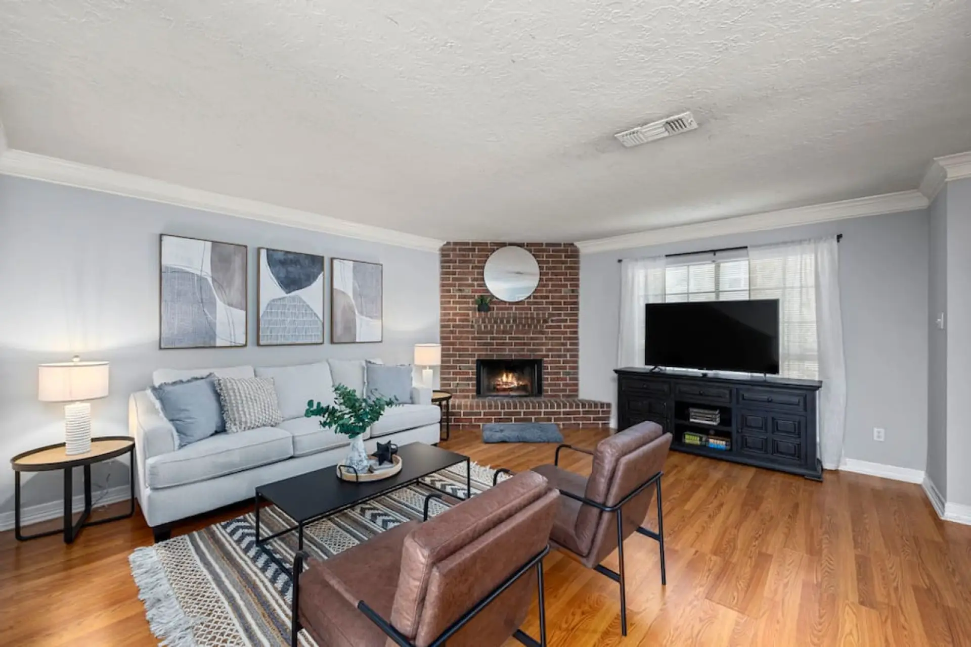 Cozy living room with fireplace, Smart TV, and comfortable seating for relaxing evenings