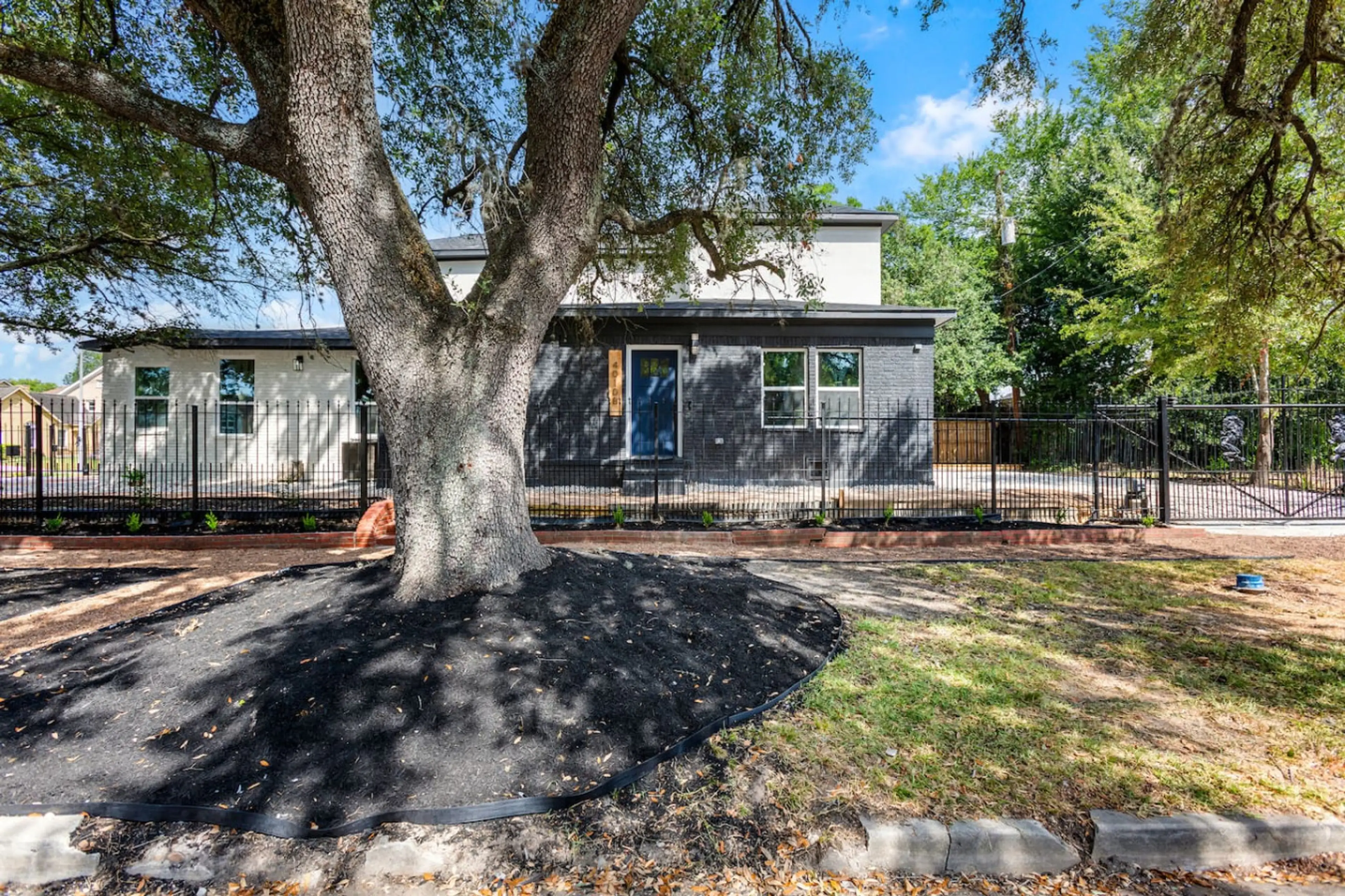 Enjoy the fenced front yard shaded by mature oak trees—perfect for fresh air or a quick break outdoors.