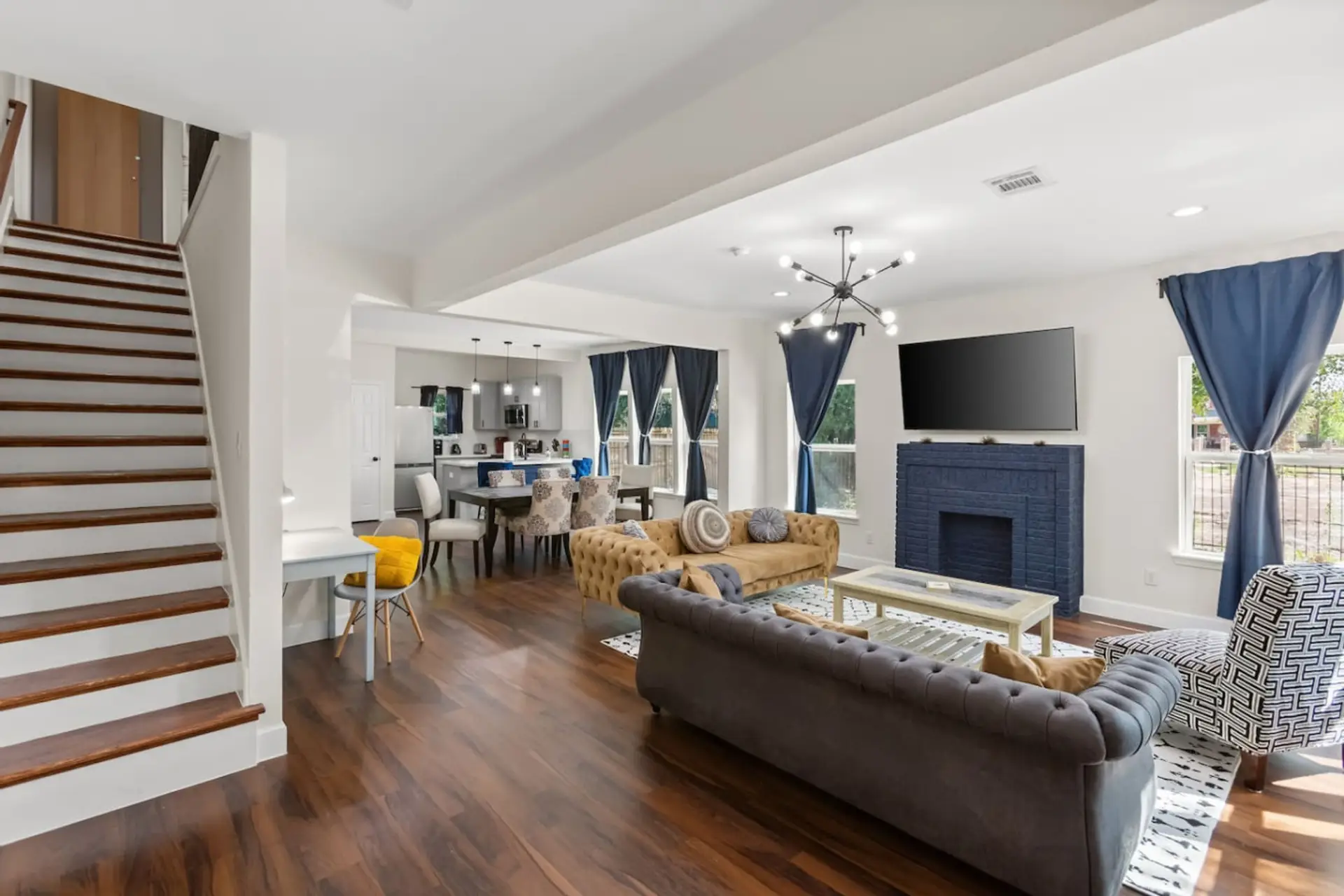 Staircase leading to upstairs bedrooms in Unit B, with living and dining areas flowing together below.