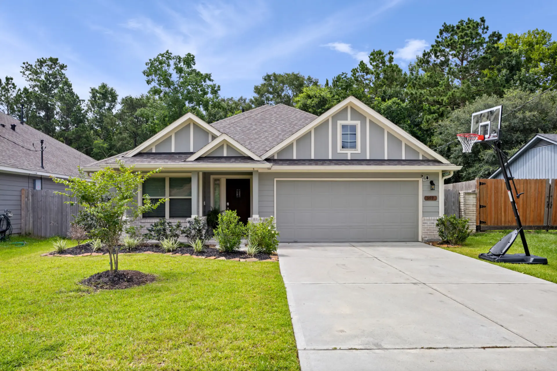 Charming single-story home with a 2-car garage, driveway basketball goal, and quiet residential setting.