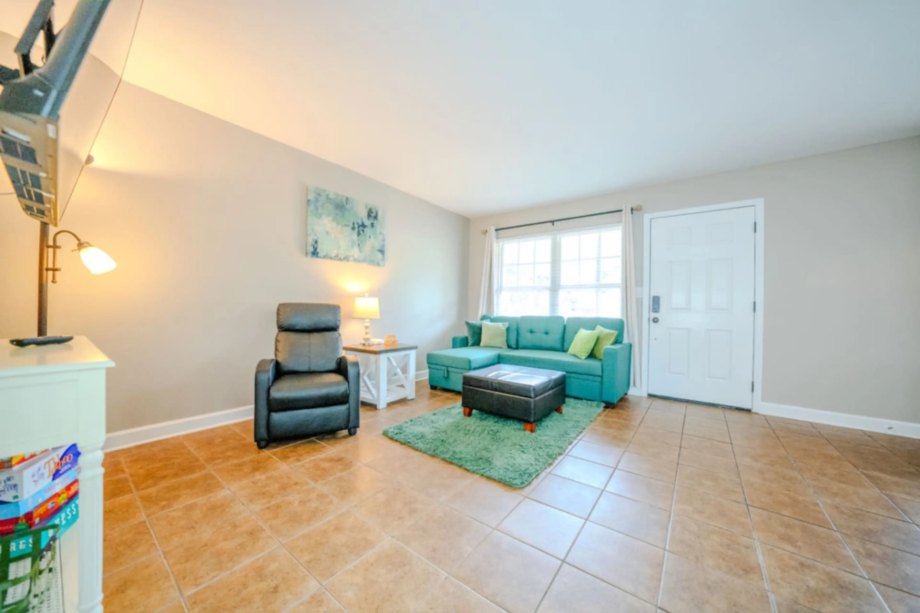 Living room with full size pull out couch (firm). 58” TV. No streaming/cable/satellite provided. Must use your own accounts to watch TV.