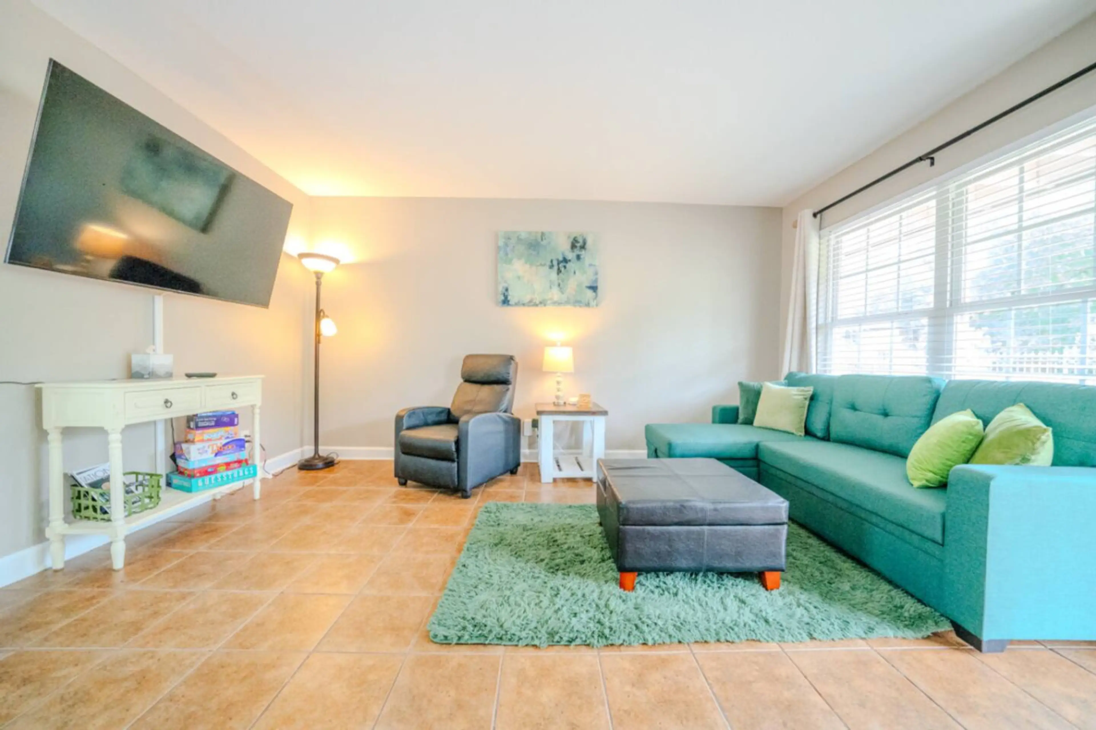 Living room with full size pull out couch (firm). 58” TV. No streaming/cable/satellite provided. Must use your own accounts to watch TV.