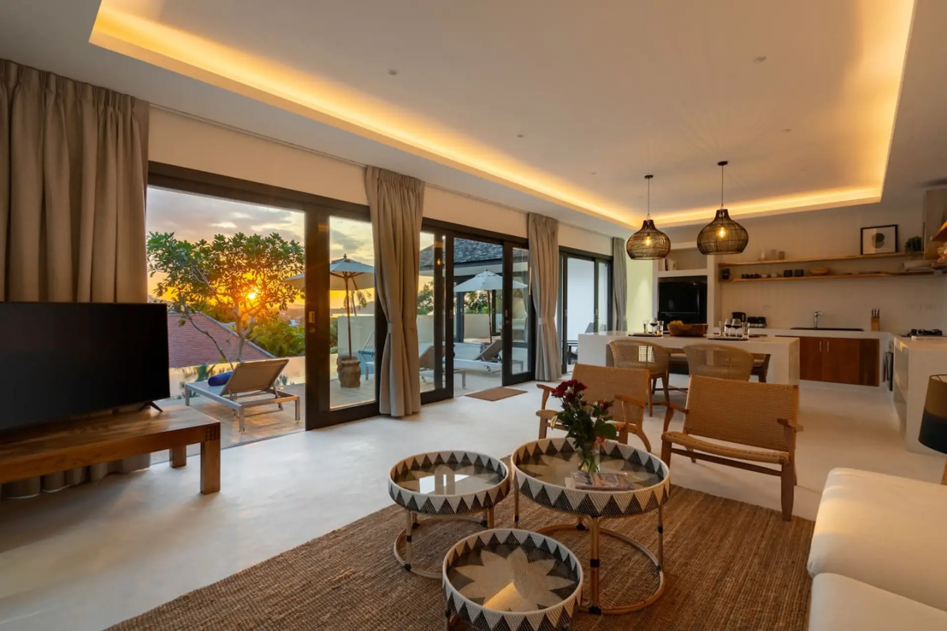 Open-plan living area with high ceilings and warm ambient lighting
