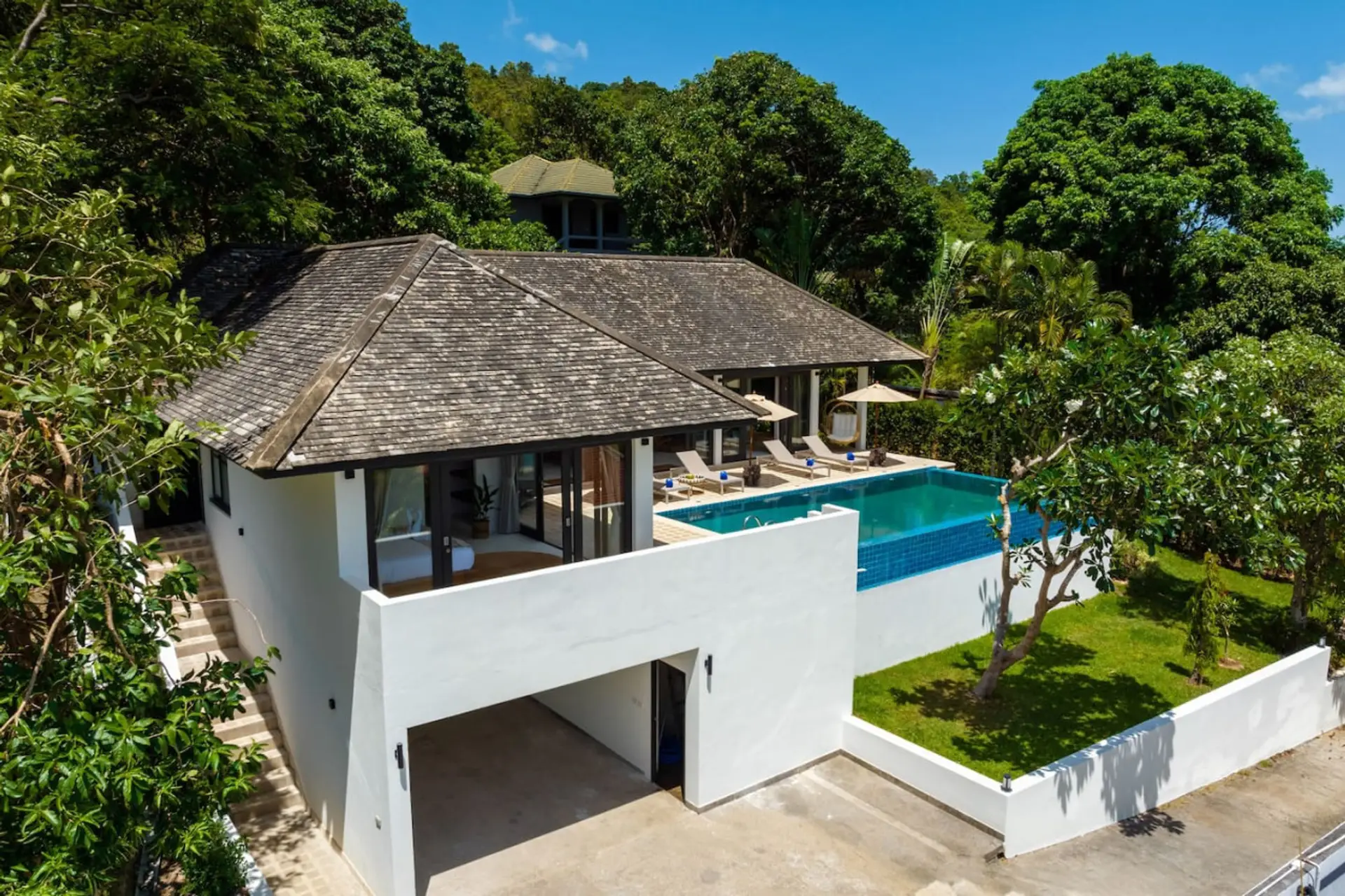 Traditional Thai-style villa with lush tropical gardens