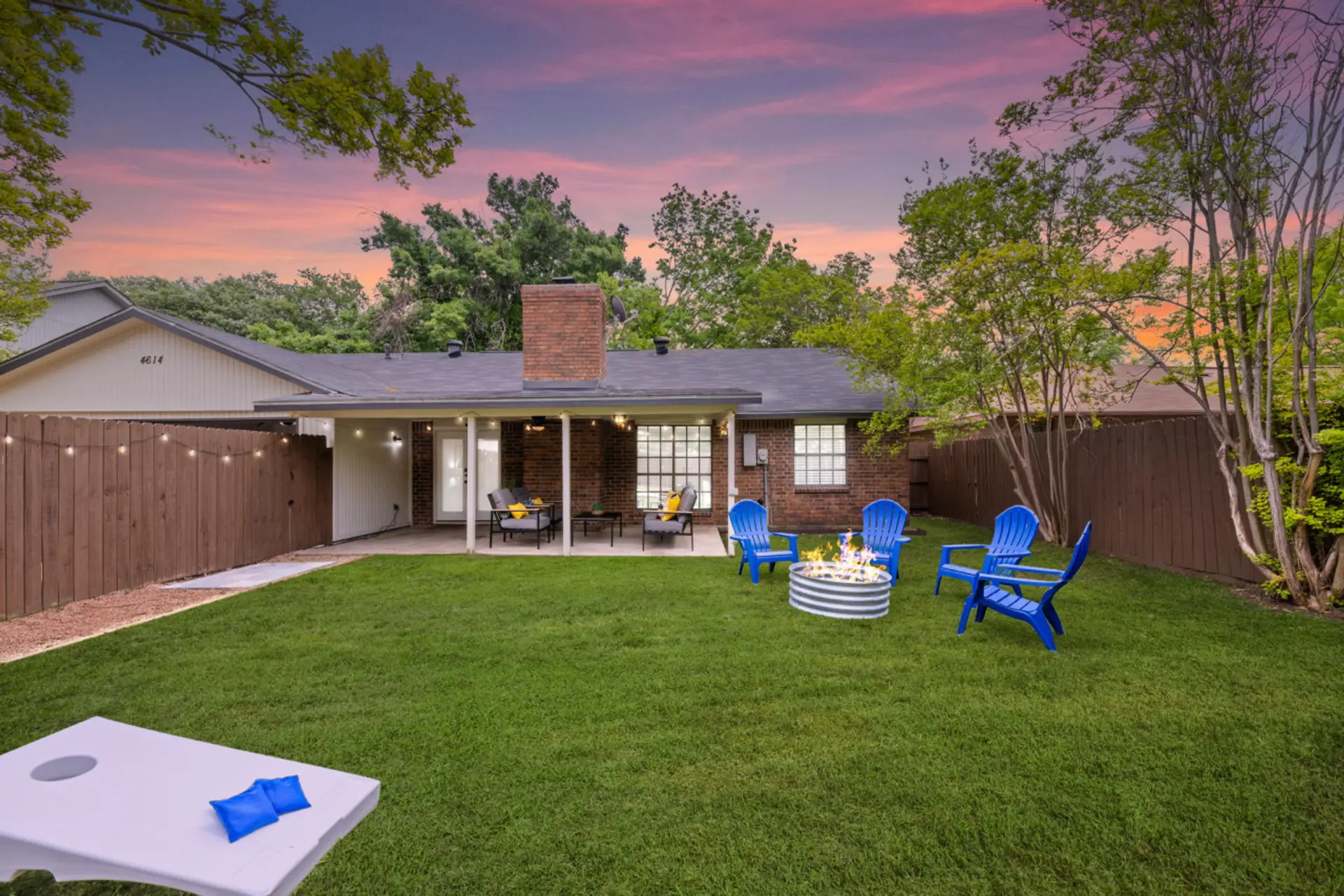 Enjoy the private backyard with seating for 8 and corn hole surrounded by bistro lights!