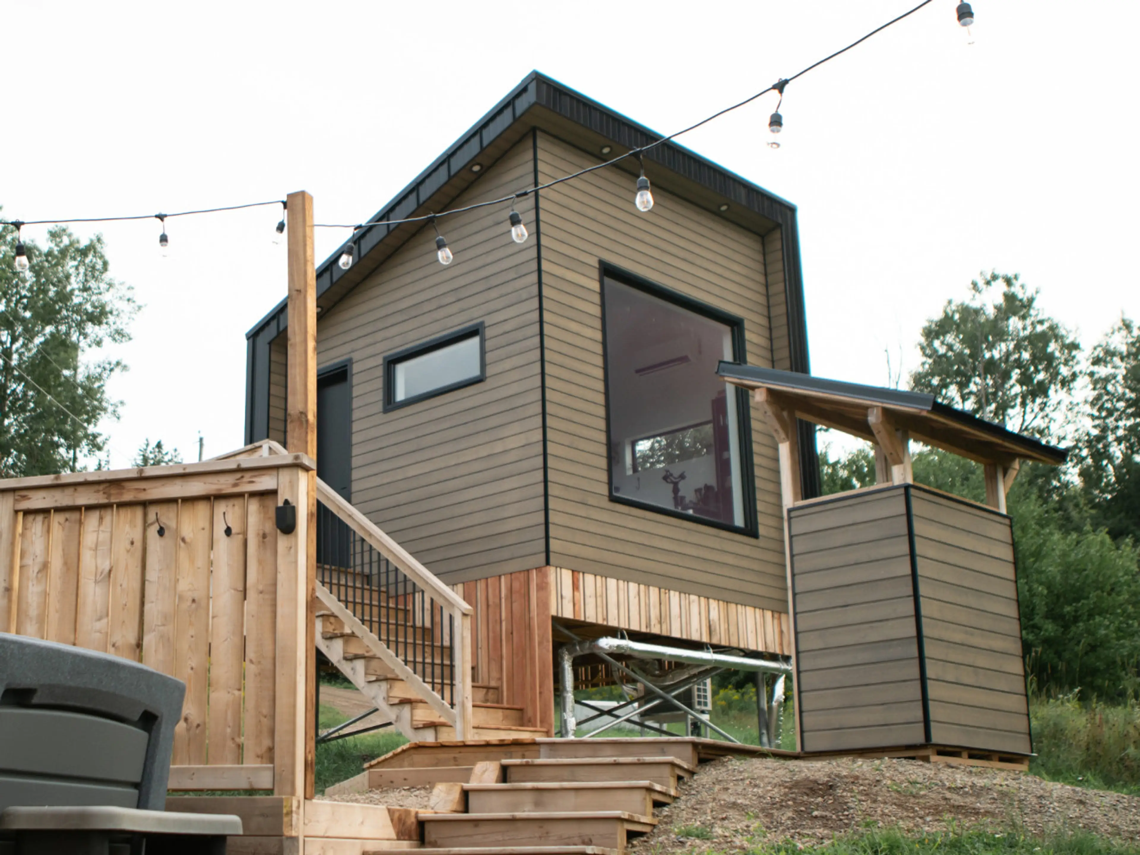 Evenings shine bright in your tiny house near Sussex—private, modern, and full of charm.