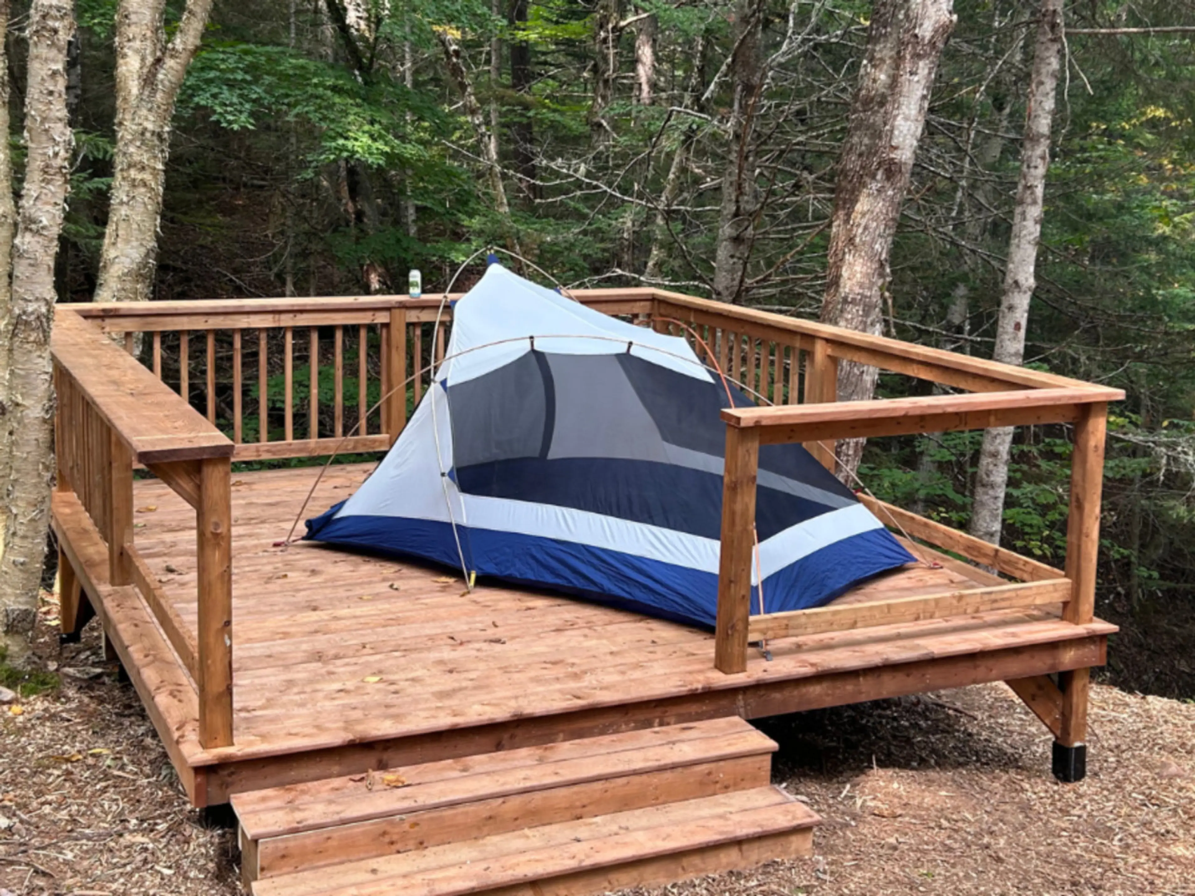 Cozy setup on a private tent deck — perfect for solo campers or couples exploring Waterford and Sussex.