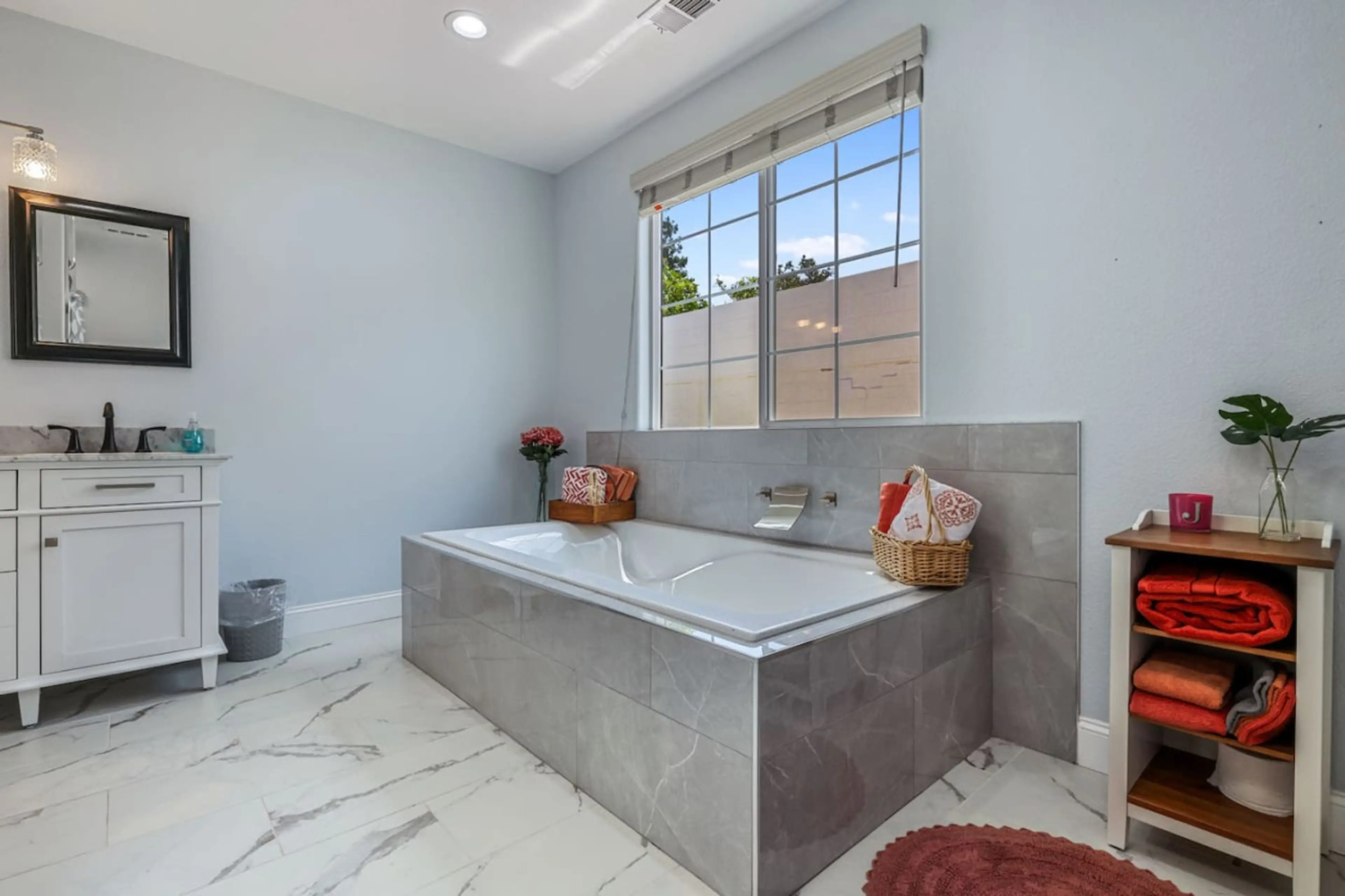 **Elegant Spa-Like Bathroom**  Indulge in luxury with our elegant spa-like bathroom. Featuring a spacious soaking tub with a modern faucet, double vanity, and chic decor, it's perfect for relaxation and rejuvenation. Book now for a serene and pampering ex
