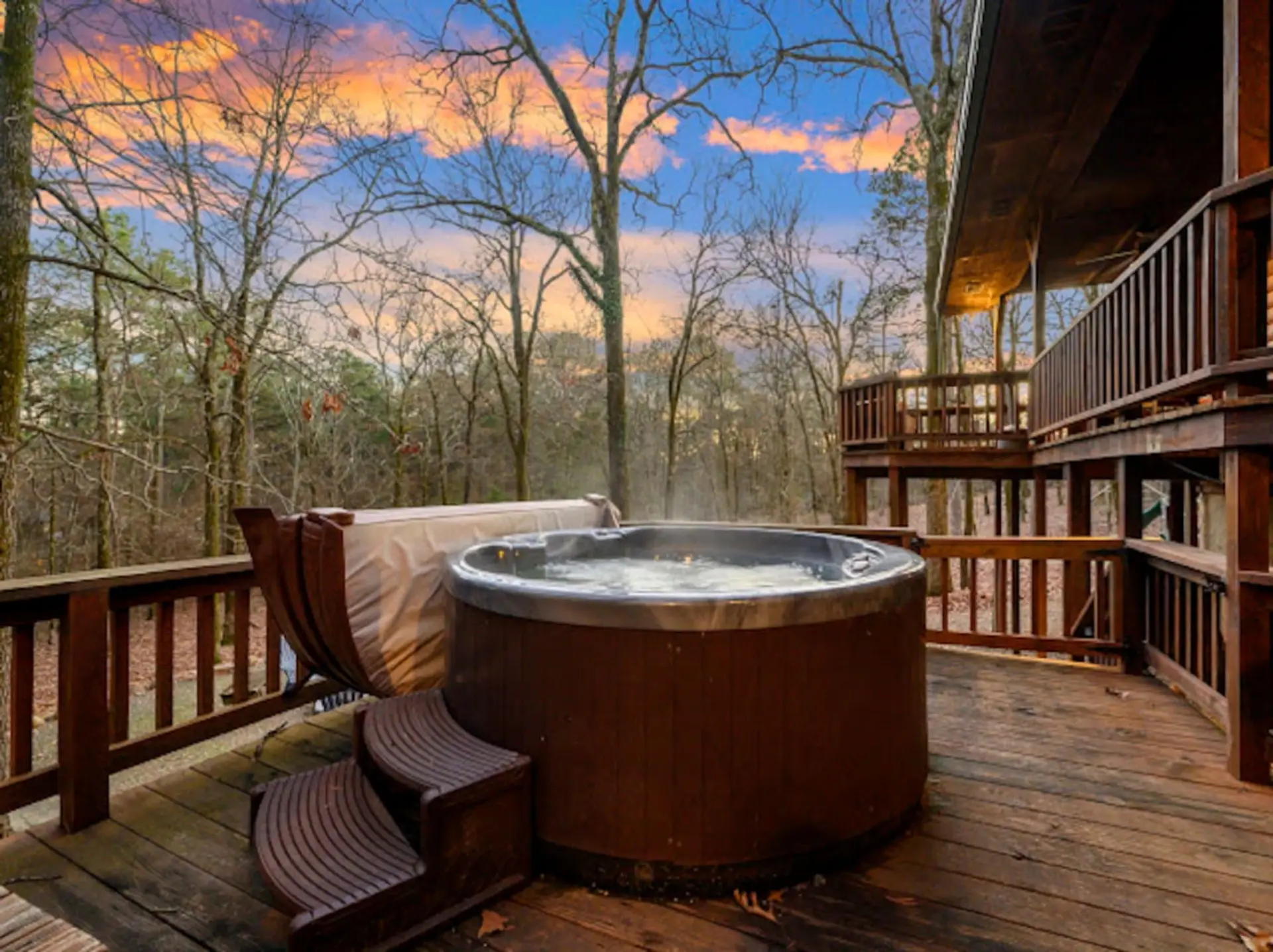 Soak in your private hot tub while watching the sunset paint the sky over endless forested hills.