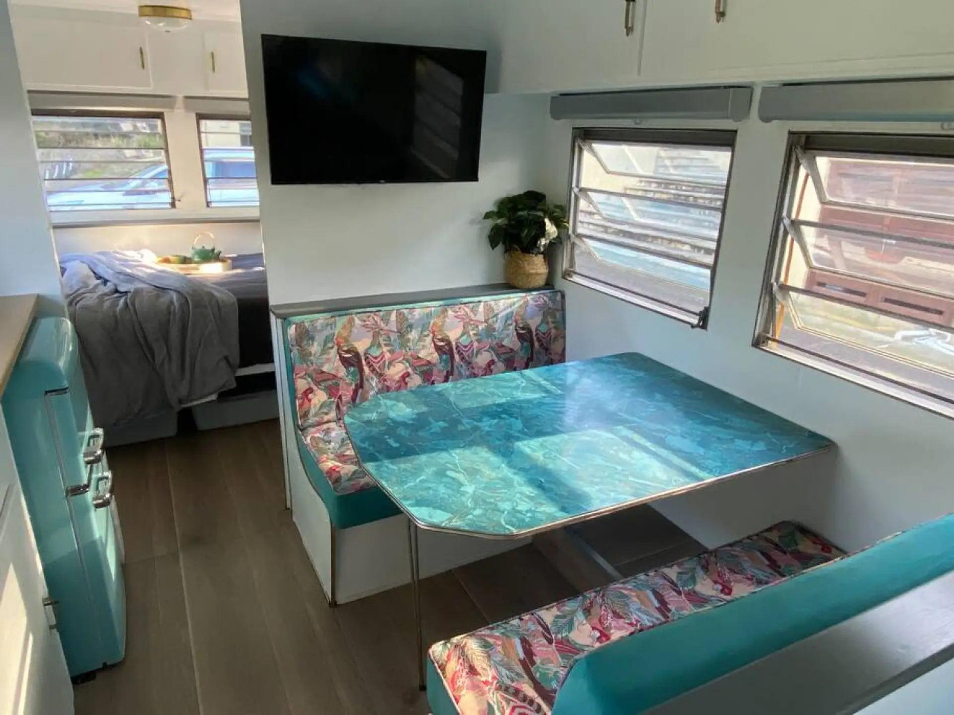 The retro dining tabletop informed all of the colours and styling of this luxurious 23ft vintage, retro caravan. The dinette comfortably seats four adults.