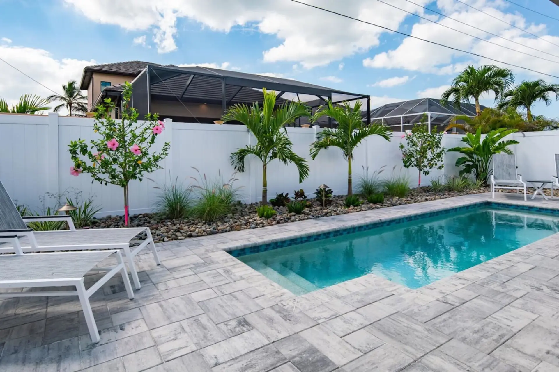 Outdoor Oasis: Dive into relaxation by the sparkling pool surrounded by tropical beauty!