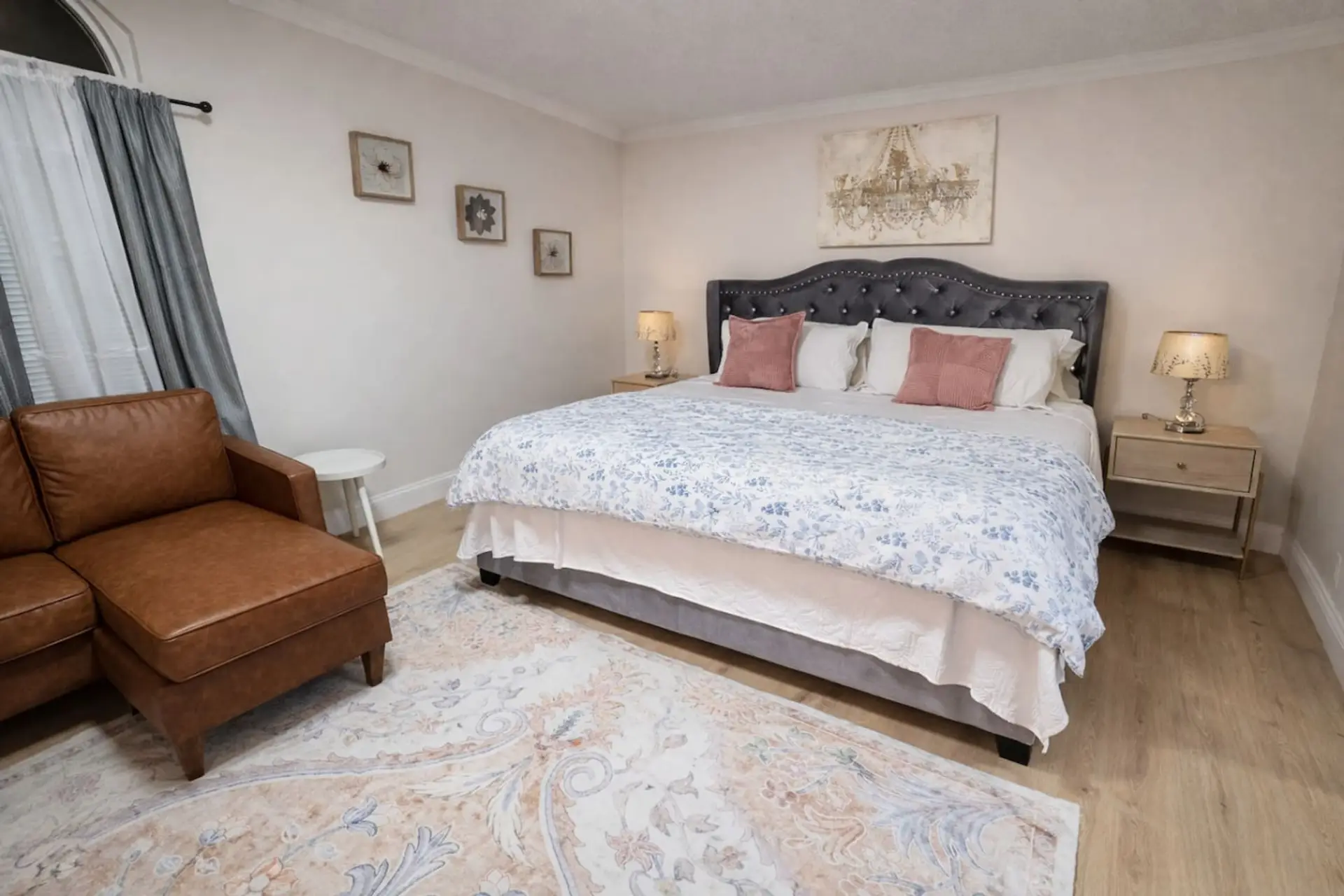 Unwind in this spacious primary bedroom featuring a luxurious king bed, room-darkening shades for a restful night's sleep, and a large TV, all complemented by full climate control and essential storage for a perfectly comfortable stay.