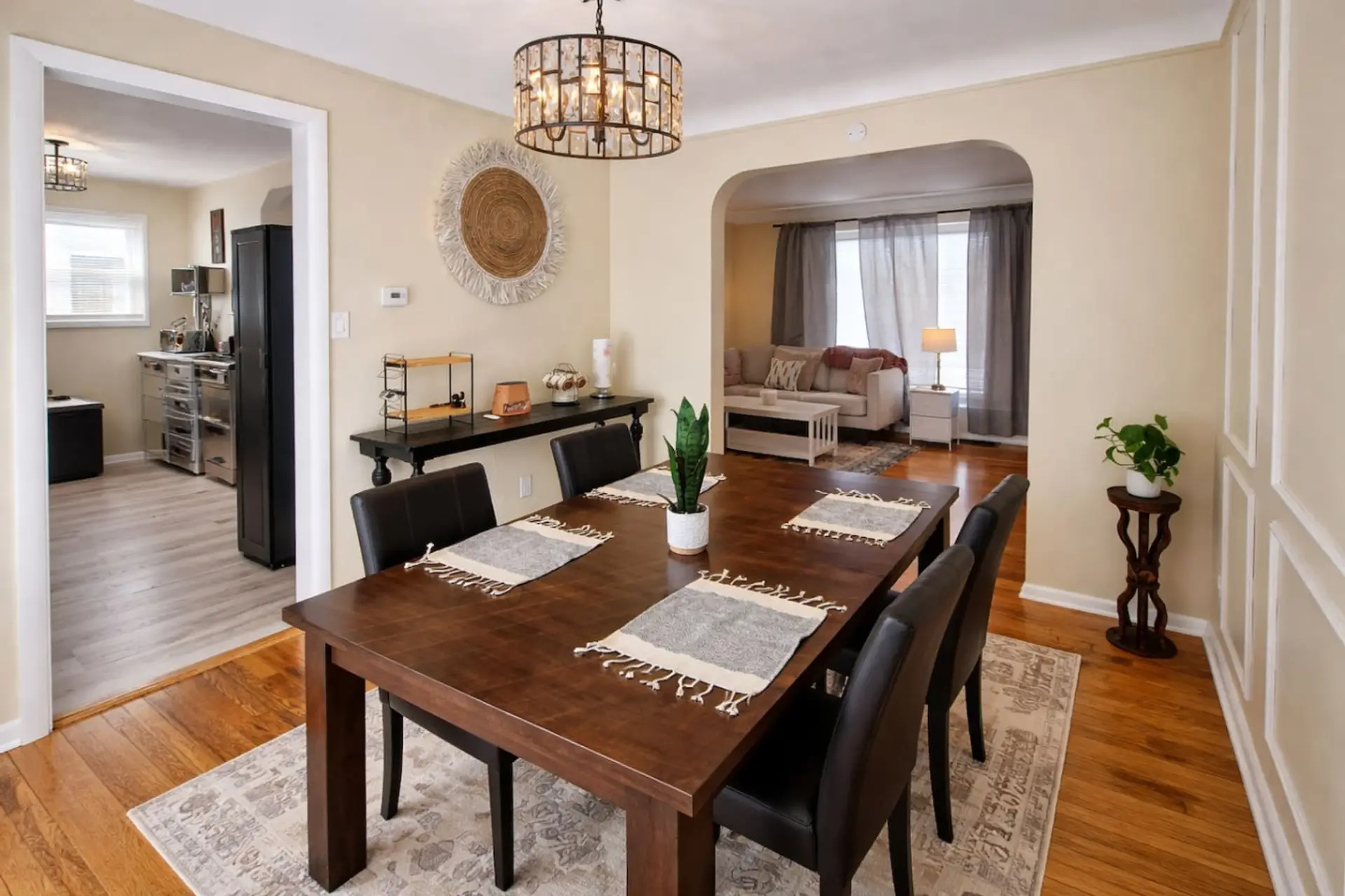Featuring a spacious dark wood table and a statement chandelier, it’s the perfect spot for everything from a quick breakfast to a celebratory dinner. The open-concept layout keeps you connected to the living room, ensuring a bright and social atmosphere f