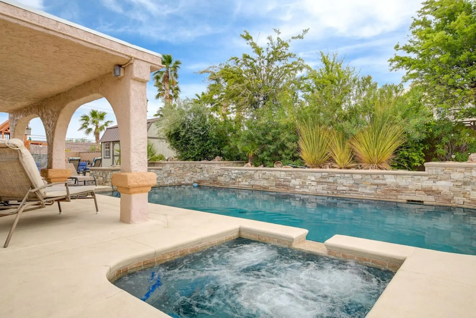 Enjoy soaking in our private hot tub while gazing at the sparkling pool beyond. Picture yourself unwinding here after exploring Las Vegas, letting the warm bubbles melt your stress away.