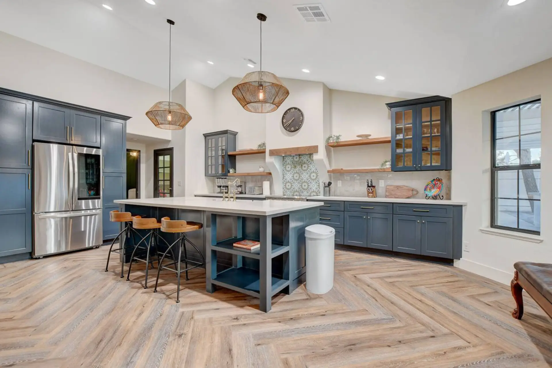 The massive center island features beautiful quartz countertops and comfortable, industrial-chic barstools—perfect for sipping wine while the chef prepares dinner or enjoying a casual morning breakfast.