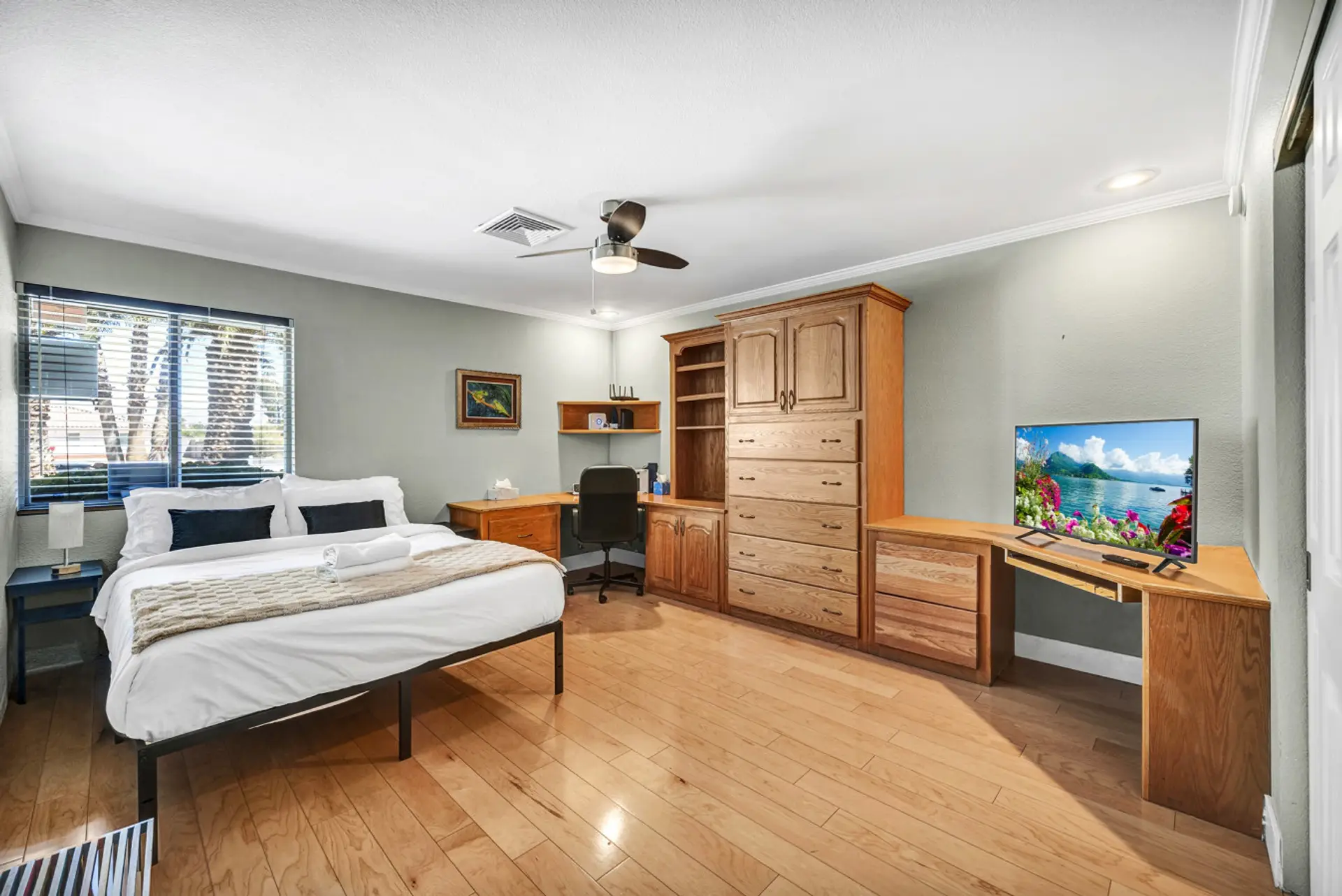 This expansive bedroom maximizes comfort and utility