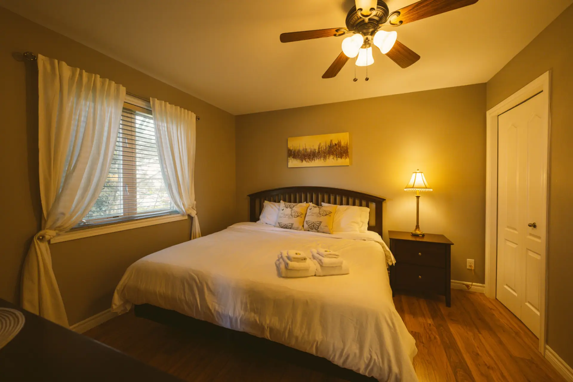 The main floor bedroom with king size bed, walk-in closet and en suite bathroom is the perfect spot to relax after a day at the wineries. The room provides accessibility features in the bathroom, and entranceways.