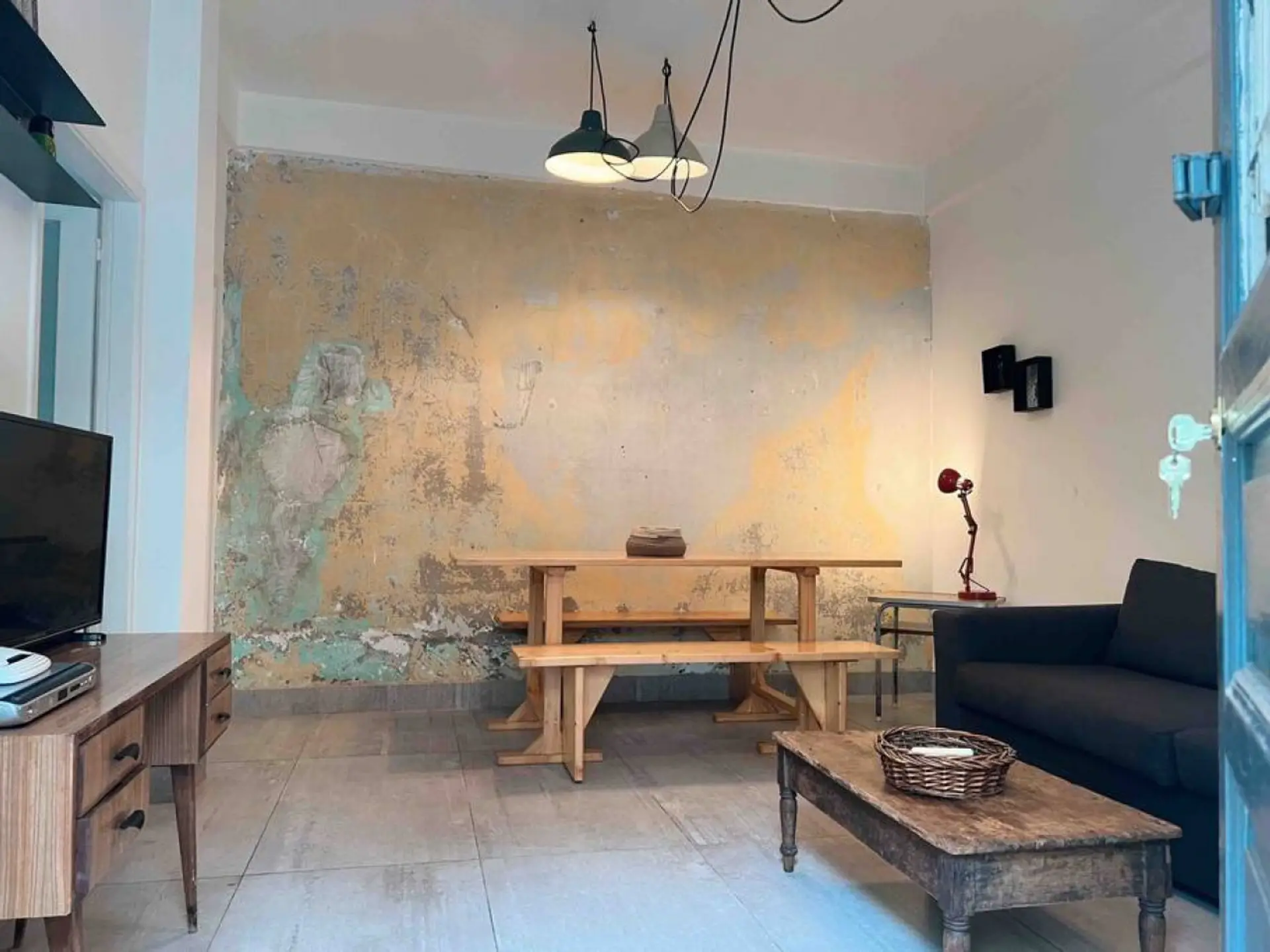 Relax in a rustic living area with a dining set and entertainment setup.