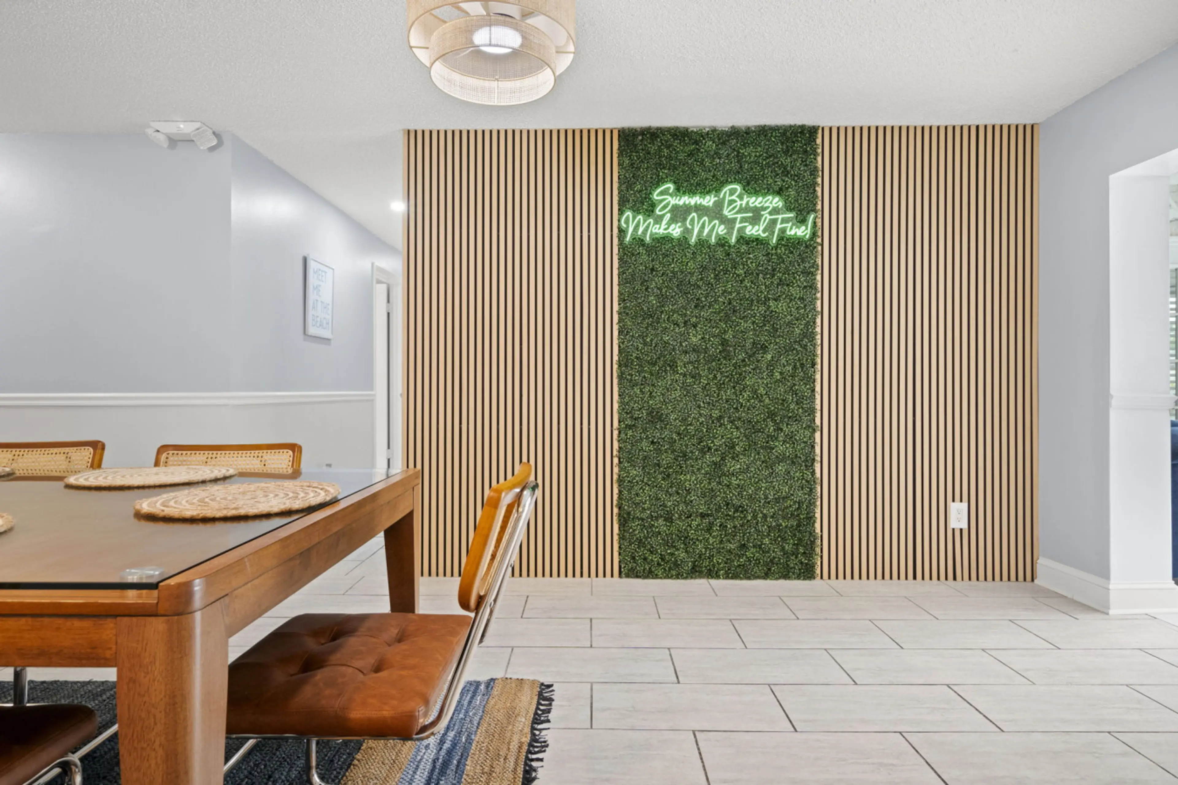 Photo op! Our neon sign and lush faux grass wall make the perfect backdrop for pictures of your ultimate island escape!
