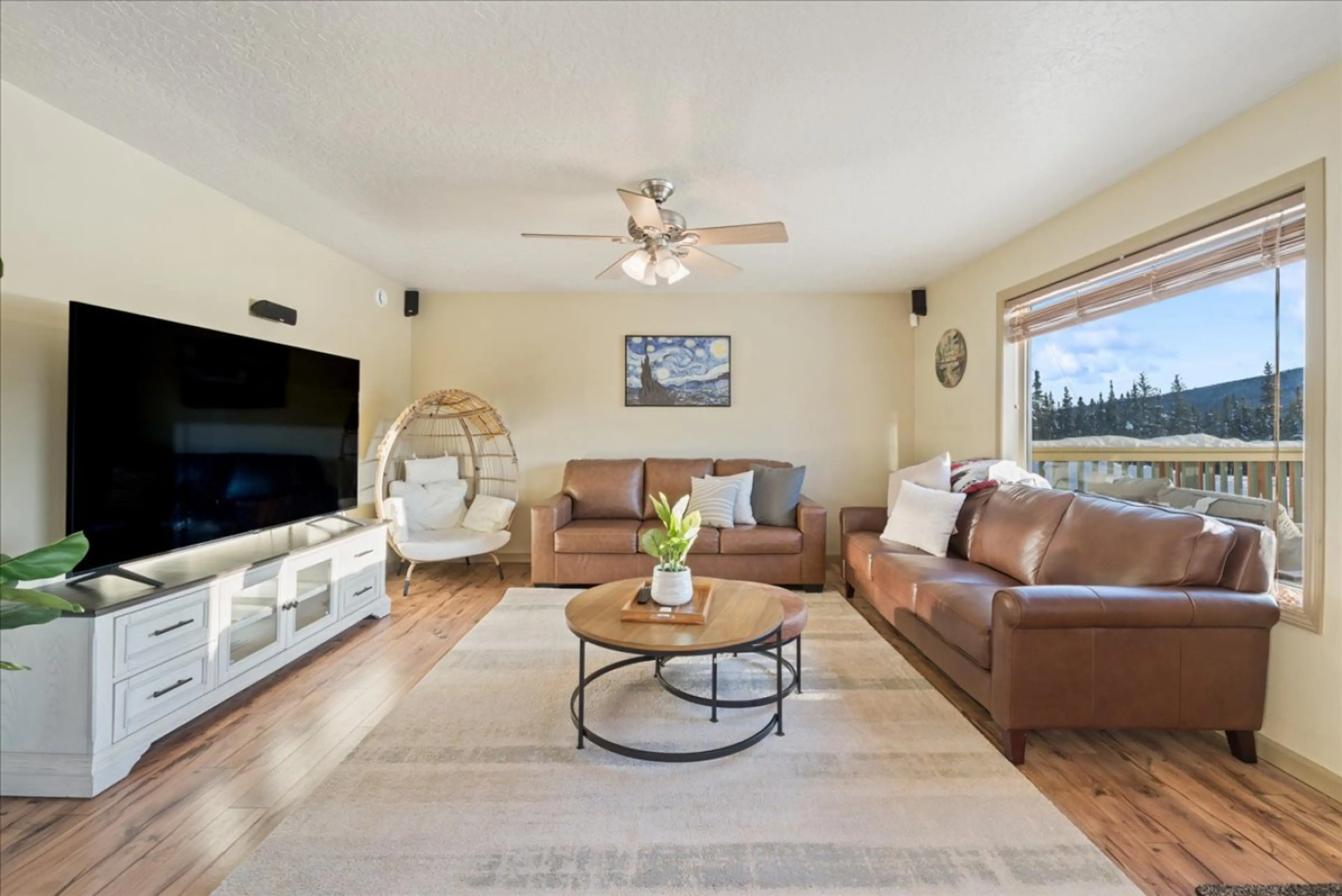 Living room with picture window, smart tv and egg chair