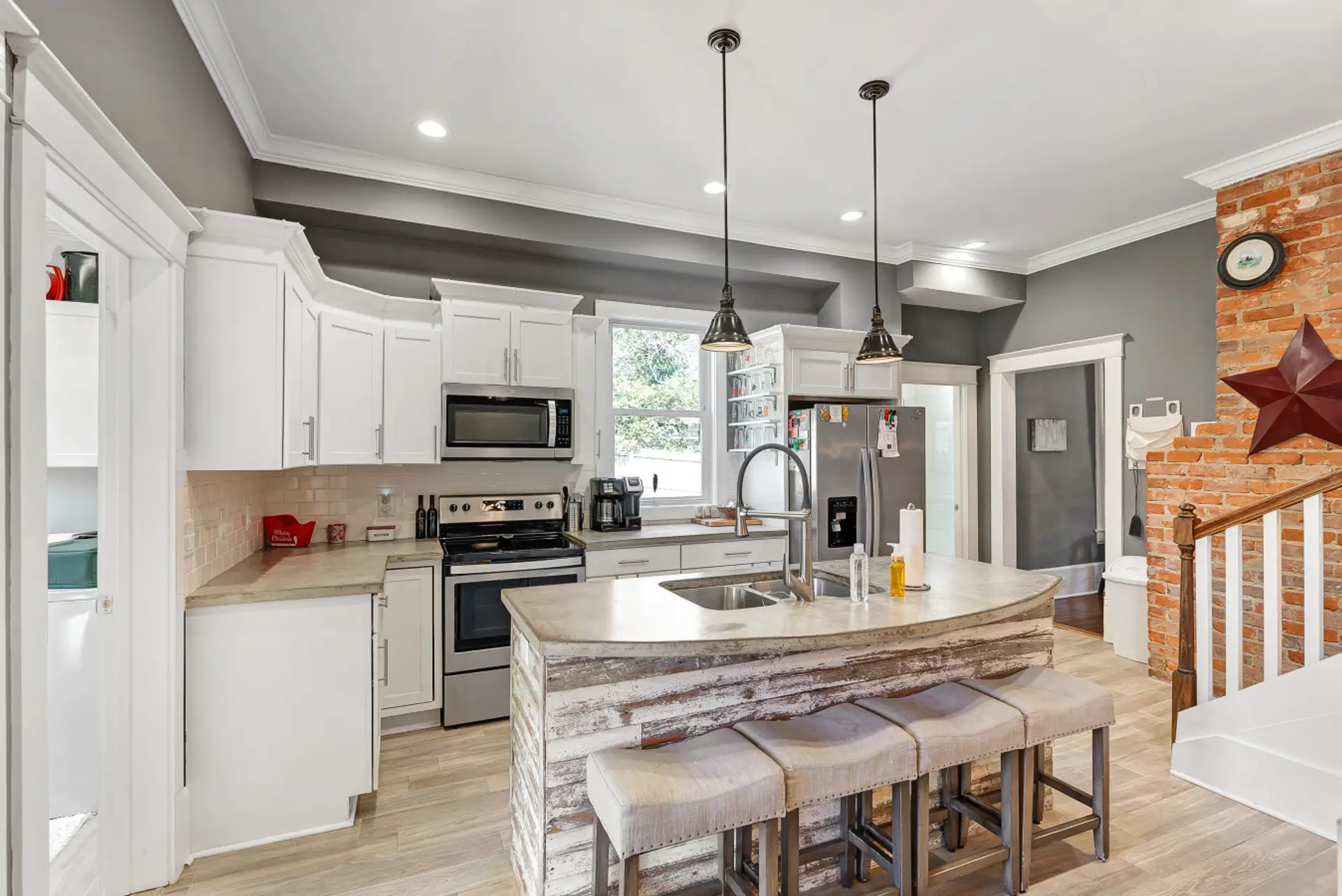 Modern Kitchen with Island Seating – Fully equipped kitchen with stainless steel appliances and bar seating.