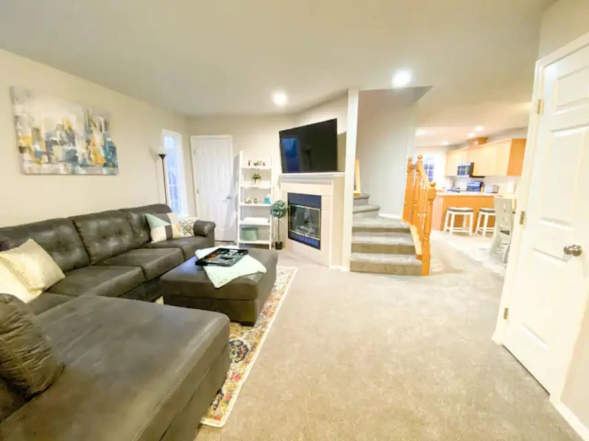 Entryway View: Huge sectional, TV, room to gather