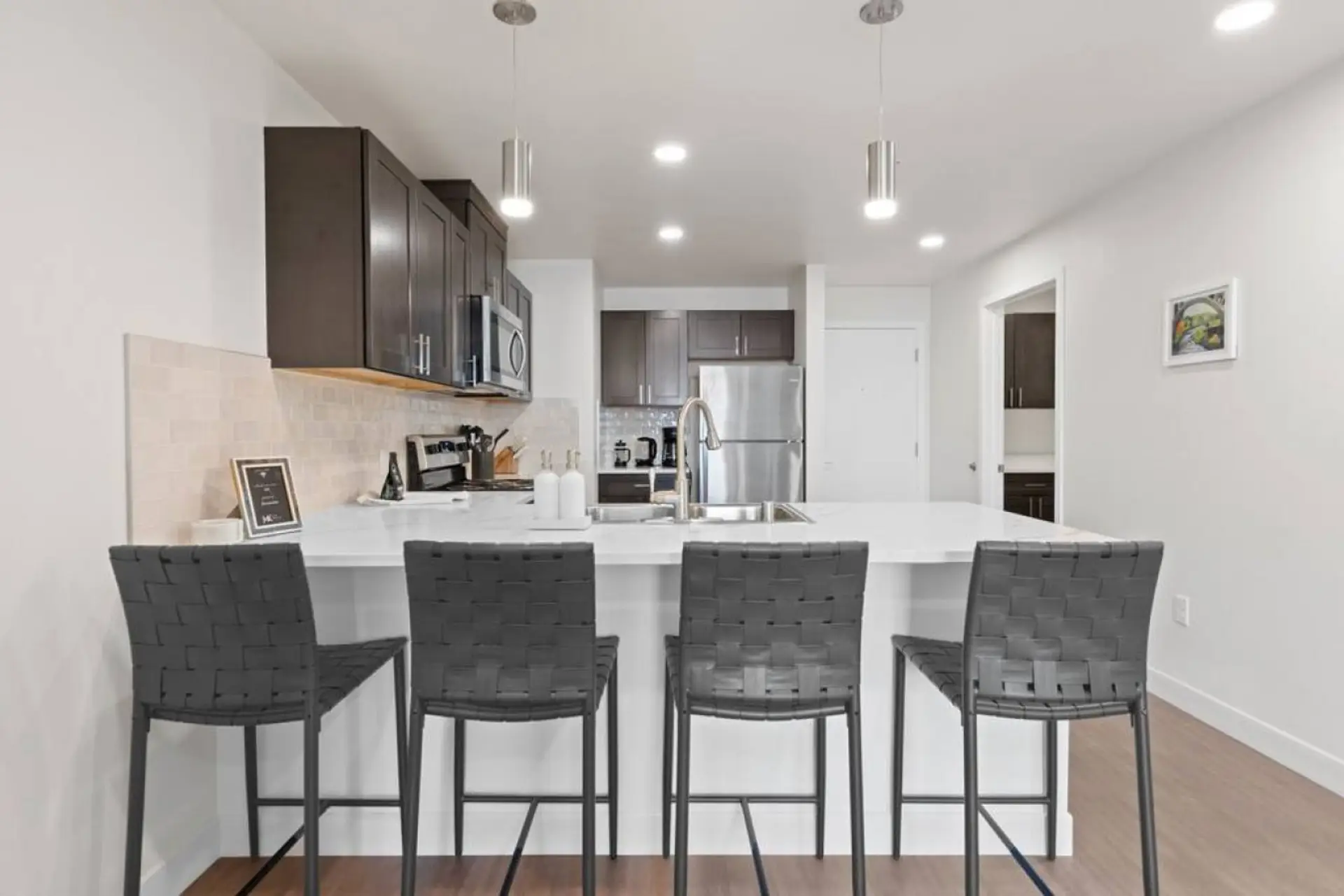 Sleek, fully stocked kitchen with high-end appliances—perfect for home-cooked meals or morning coffee.